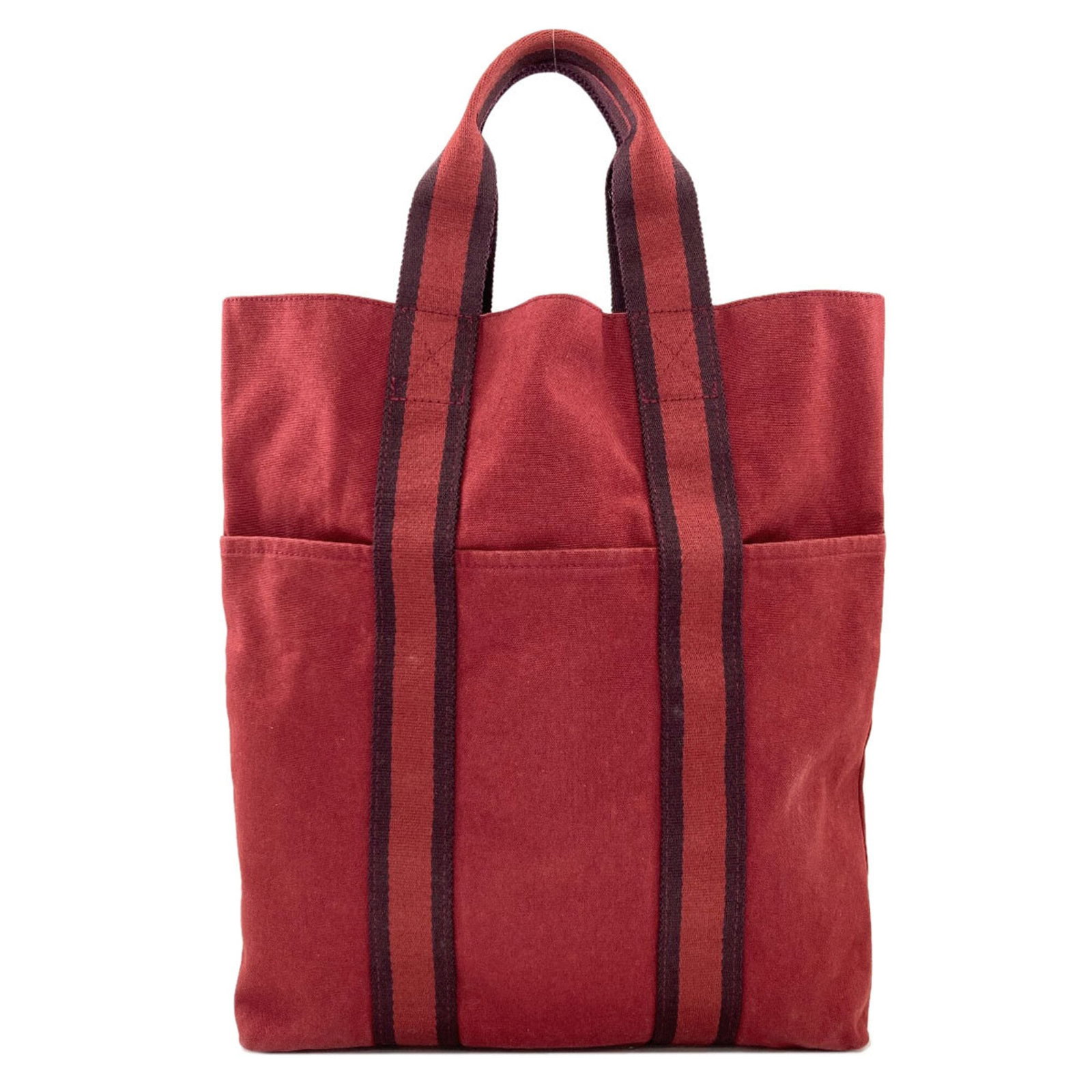 Canvas Hermes Tote Bag: Canvas Hermes Tote Bag Canvas tote bag from the iconic French fashion house Hermes, featuring a vibrant red color and classic design. Made from high-quality canvas material, this timeless tote