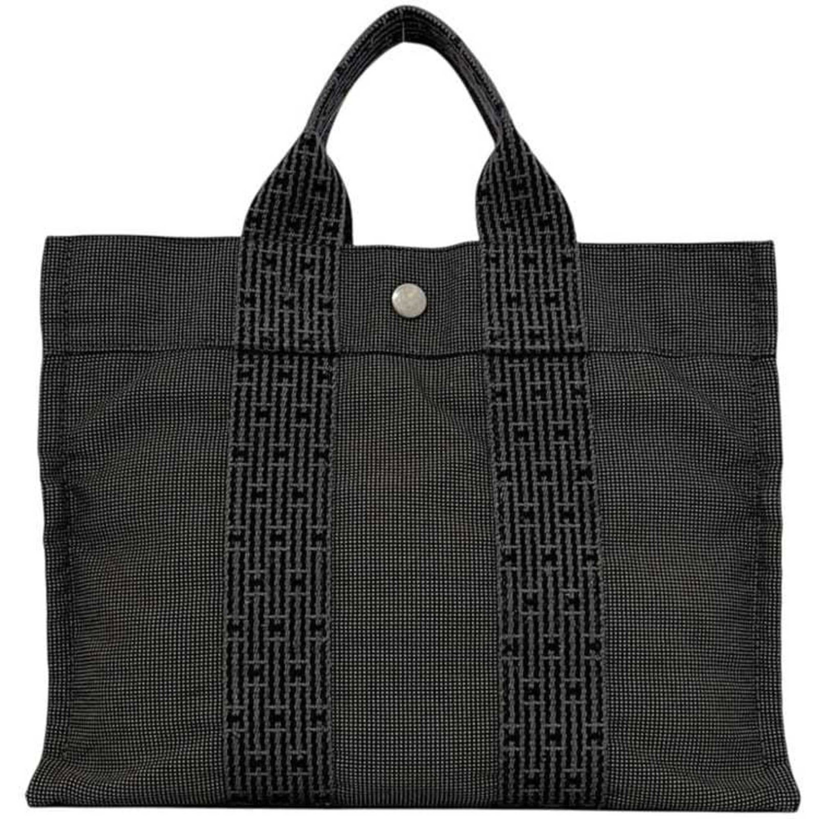 Handbag Tote Bag of Canvas by Hermes: Handbag Tote Bag of Canvas by Hermes Canvas tote bag by Hermes, crafted from high-quality canvas in a versatile gray hue. Measuring 22cm x 30cm x 8cm, this stylish and practical bag offers a spacious 