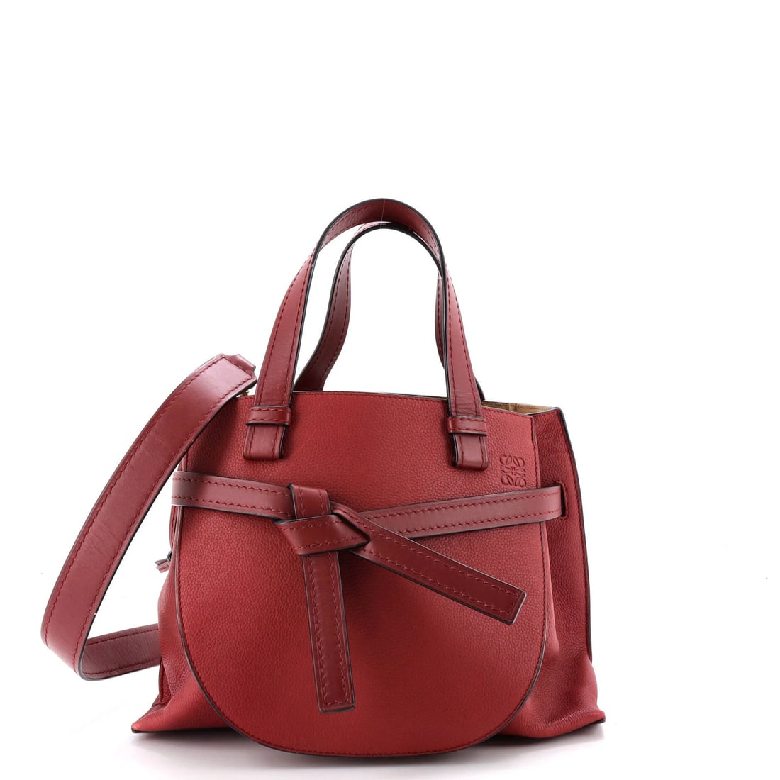 Leather Small Loewe Gate Tote: Leather Small Loewe Gate Tote Burgundy leather wraps around the Gate Tote, showcasing its rich exterior color. With gold tone hardware and suede interior, this small Loewe tote boasts a classic