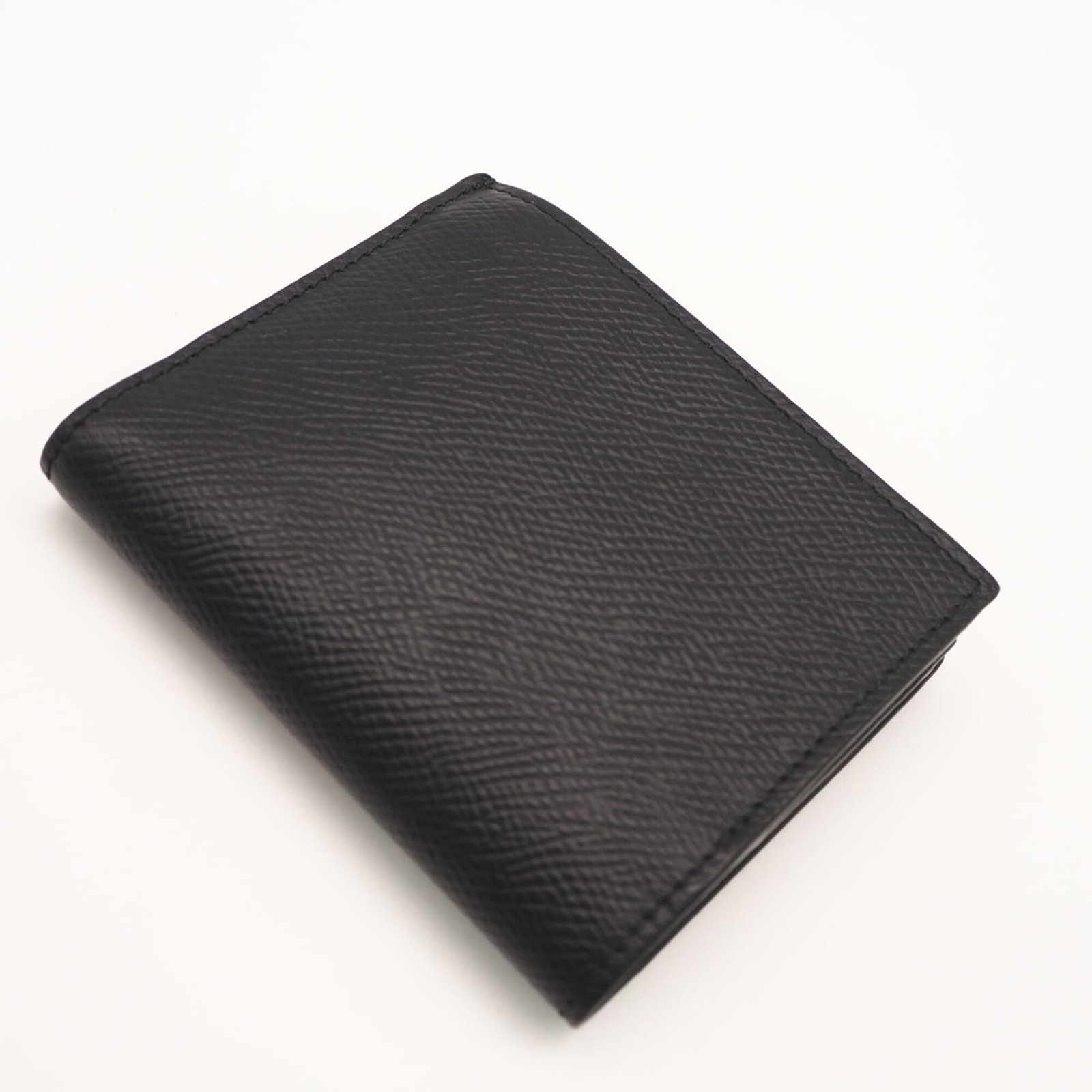 Leather Bi Fold Wallet: Leather Bi Fold Wallet Calfskin leather construction provides durability and sophistication. The sleek black design features a bi-fold layout, ideal for everyday use. Measuring 8.5cm x 10.5cm x 1cm, i