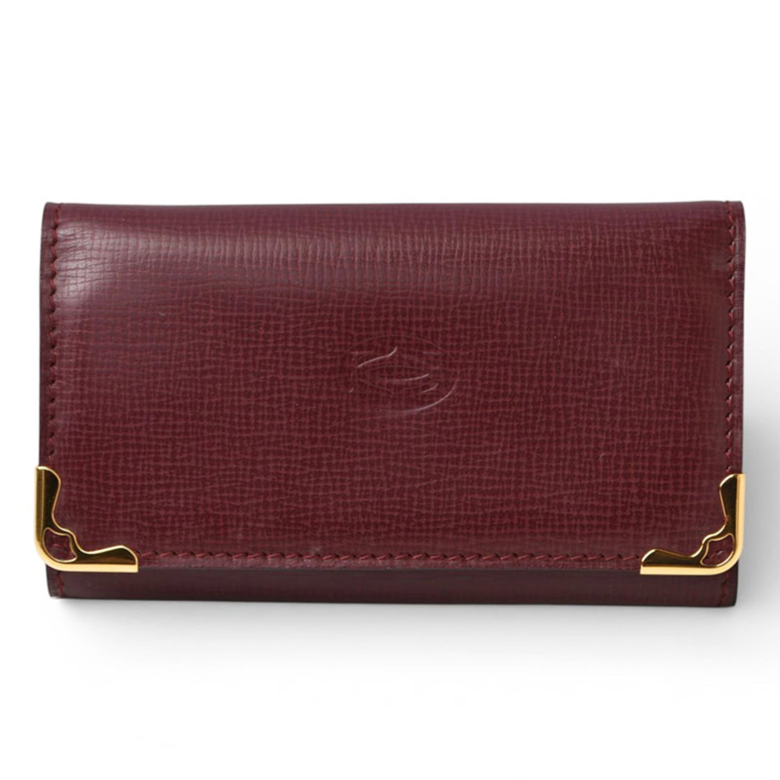 Keycase Leather by Cartier: Keycase Leather by Cartier Cartier's Keycase Leather boasts sleek, Bordeaux-hued leather and six spacious key hooks, perfect for keeping your essentials organized. Measuring just 6cm x 10cm x 1.5cm, t