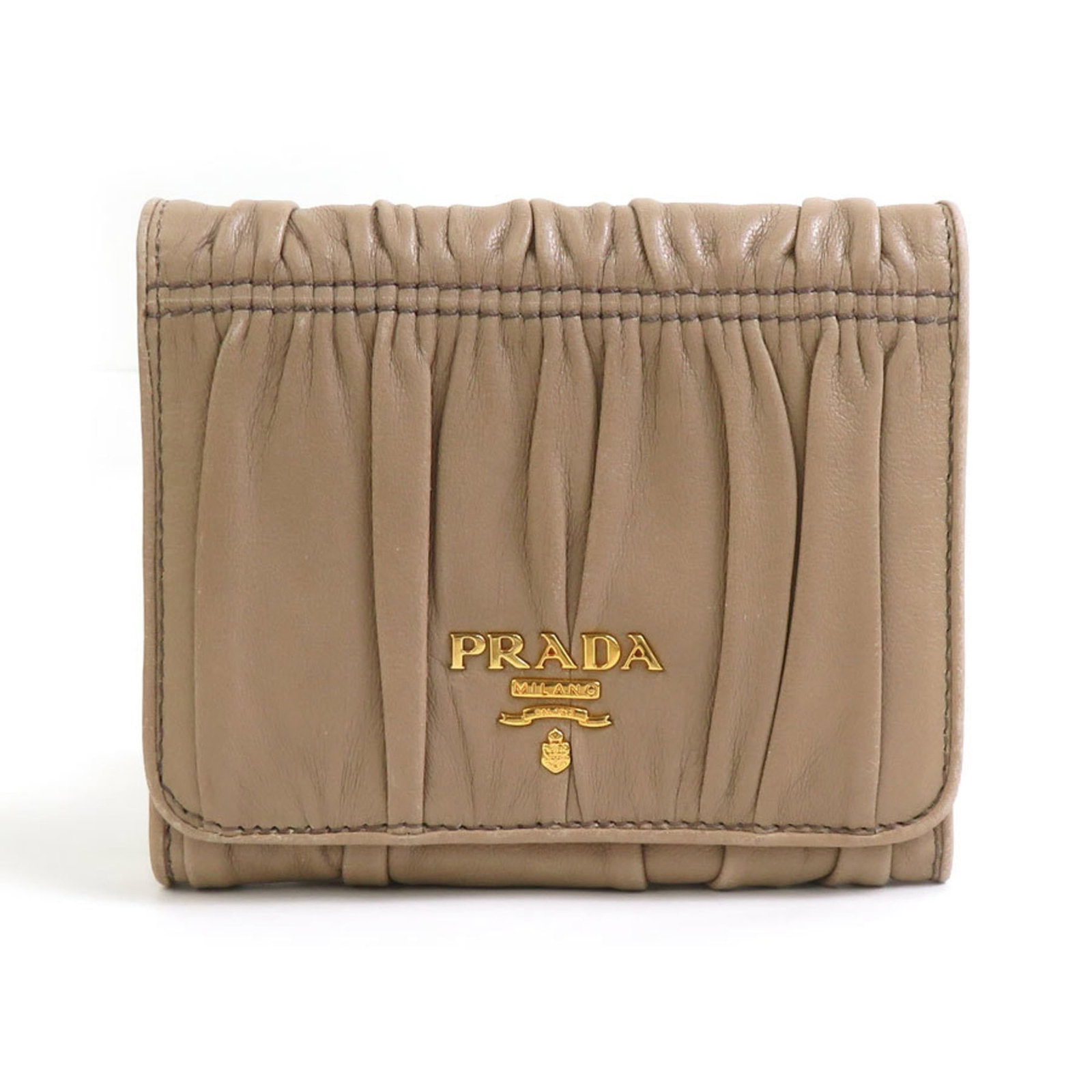 Prada Wallet (Tri-Fold) Leather: Prada Wallet (Tri-Fold) Leather Tri-fold leather wallet from Prada, featuring a classic design with clean lines and a sleek beige finish. Made from high-quality leather, this wallet measures 9.5cm x