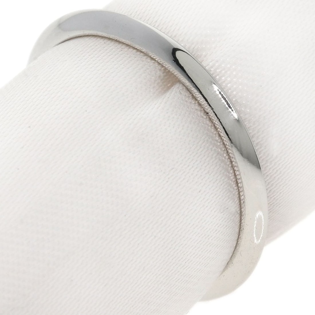 Knife Edge Ring Platinum Pt950 by Tiffany Co: Knife Edge Ring Platinum Pt950 by Tiffany Co PT950 platinum provides a strong, silver-toned metal for the Knife Edge Ring by Tiffany Co. This style features no main stone, showcasing its sleek