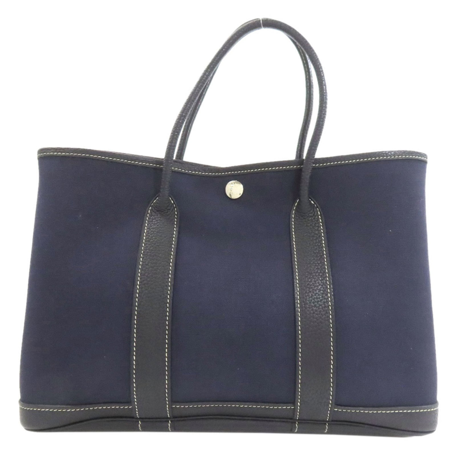 Officier Toile Bag Hermes Tote: Officier Toile Bag Hermes Tote Navy Toile Officier Tote Bag from Hermes, measuring 21cm x 30cm x 13cm. This iconic tote features the classic Toile Officier design, a timeless and sophisticated pattern
