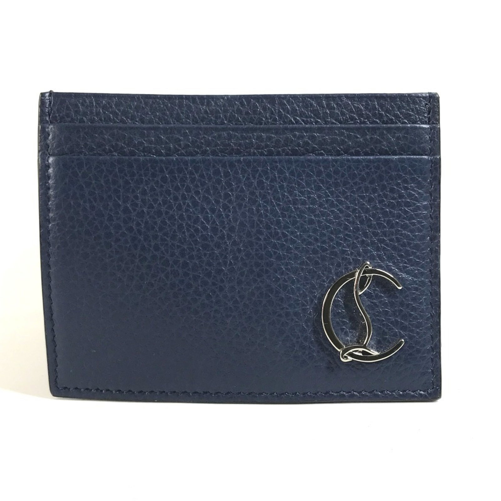 Christian Louboutin Case Leather Business Card: Christian Louboutin Case Leather Business Card This Christian Louboutin leather business card case features a sleek navy design, showcasing the iconic brand's signature style. Made from high-quality l