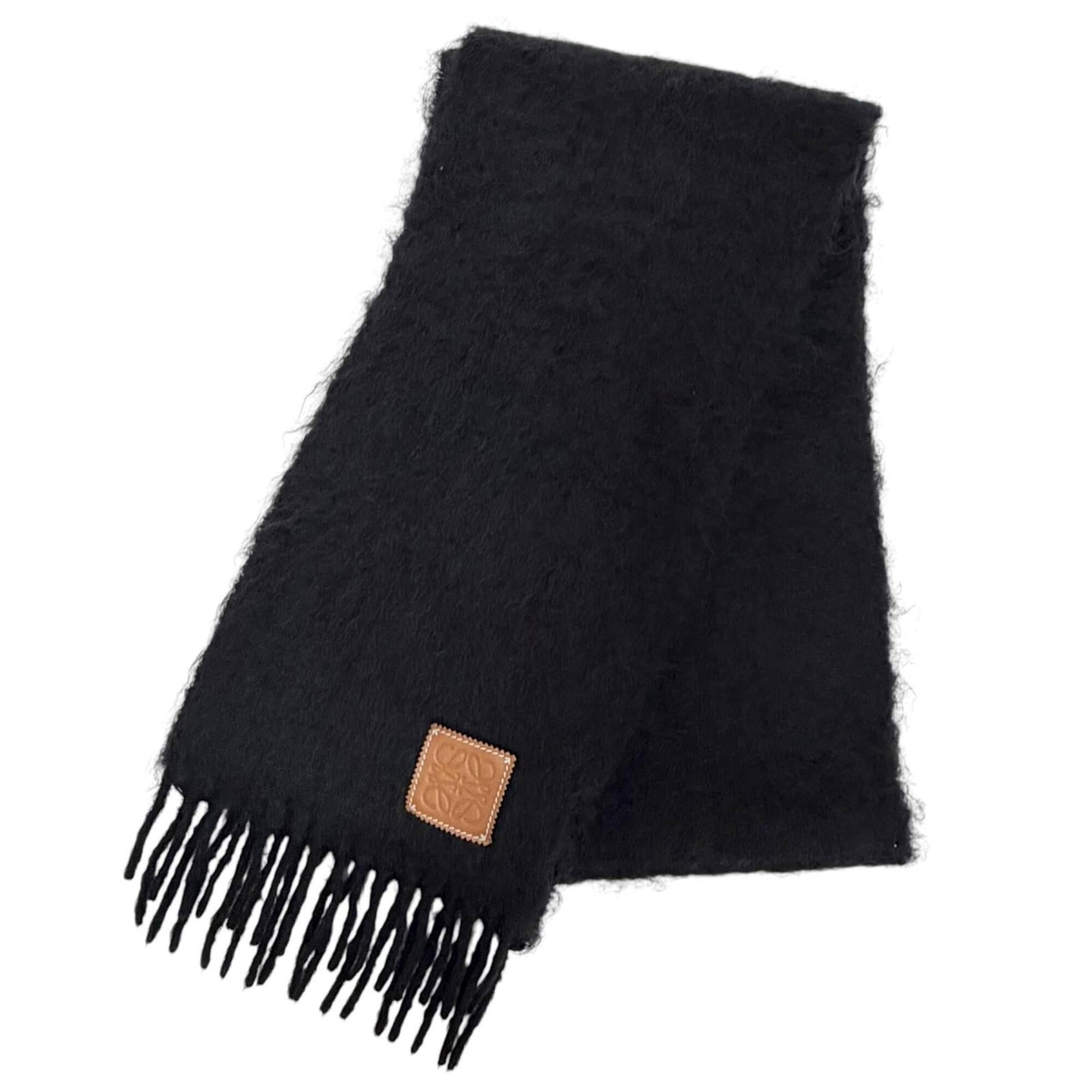 Stole Mohair Wool Nylon Loewe: Stole Mohair Wool Nylon Loewe Stole made from Mohair, Wool, and Nylon fabric, measuring 1.85m x 23cm in size, with a black color. This unique stole features a blend of materials, combining the warmth 
