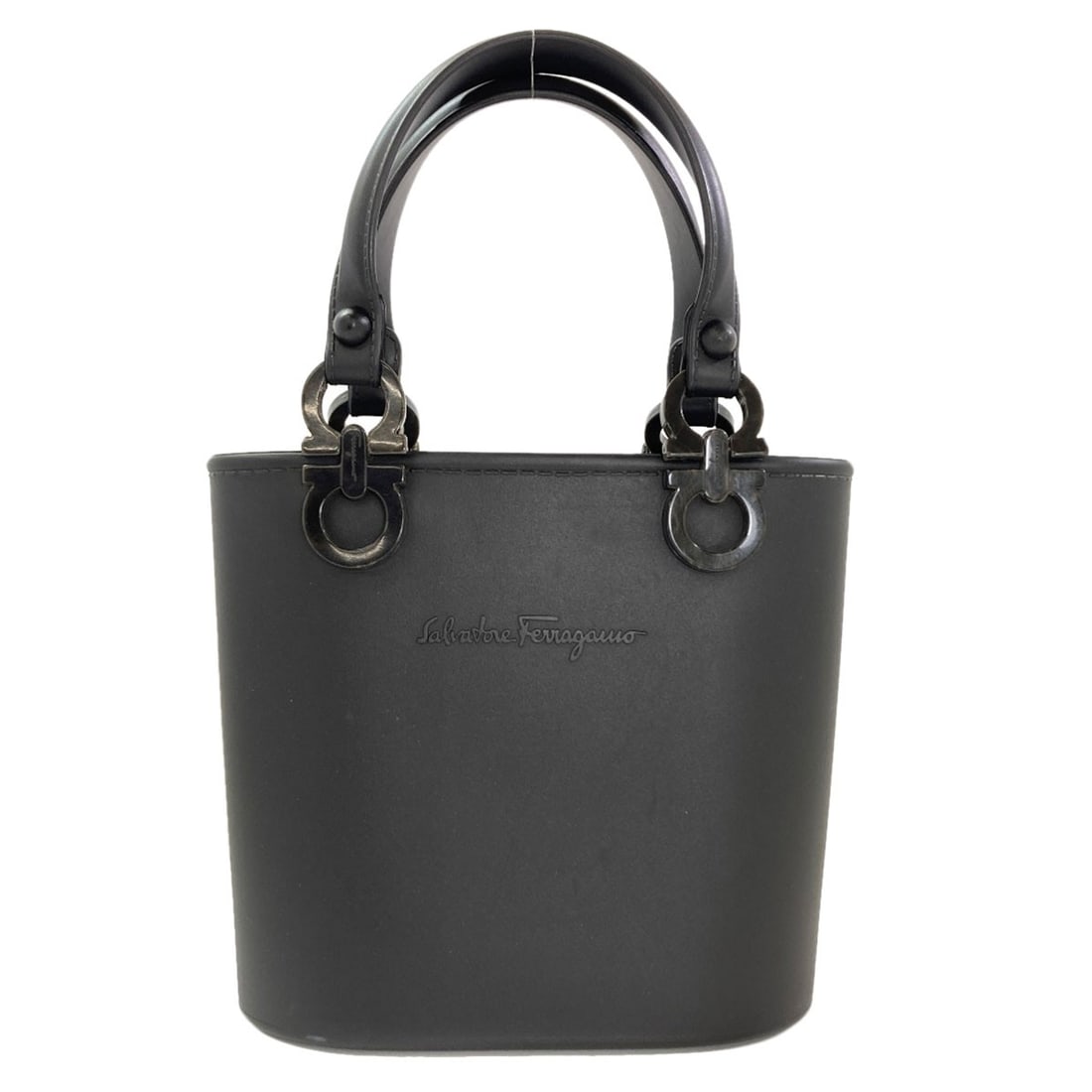 Rubber handbag gancini by ferragamo salvatore: Rubber handbag gancini by ferragamo salvatore Black rubber handbag gancini by Ferragamo Salvatore features a distinctive black exterior made from rubber. The rubber material provides a unique texture