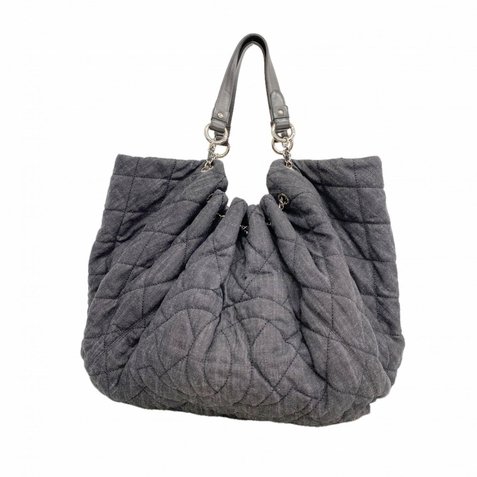 Denim tote bag by Chanel: Denim tote bag by Chanel Chanel's iconic denim tote bag boasts sleek black denim and silver hardware, making for a chic and sophisticated accessory. Measuring 39cm x 41cm x 20cm, it offers ample