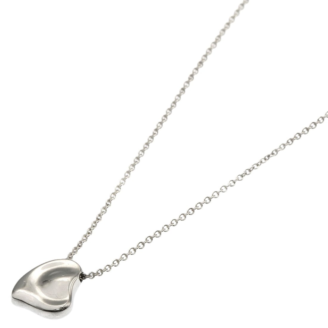 Full heart necklace silver from Tiffany Co: Full heart necklace silver from Tiffany Co Silver heart necklace from Tiffany Co, featuring a sleek and modern design with no stone. This 16.3-inch long necklace showcases the brand's signature style