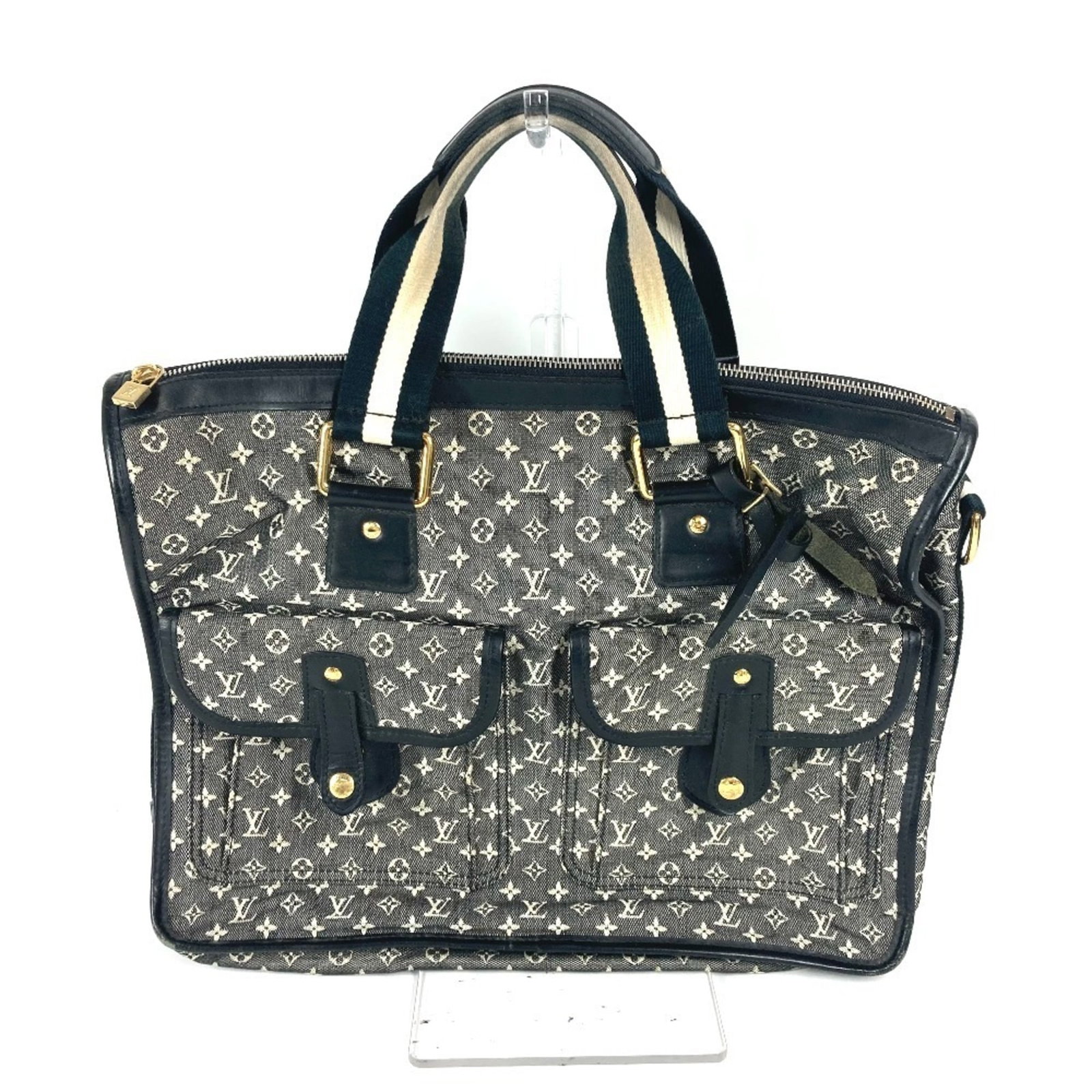 Vuitton Handbag Louis Tote Monogram Mini: Vuitton Handbag Louis Tote Monogram Mini The Louis Vuitton Handbag Louis Tote Monogram Mini features the iconic monogram pattern, a signature design element of the brand. This compact tote bag measure
