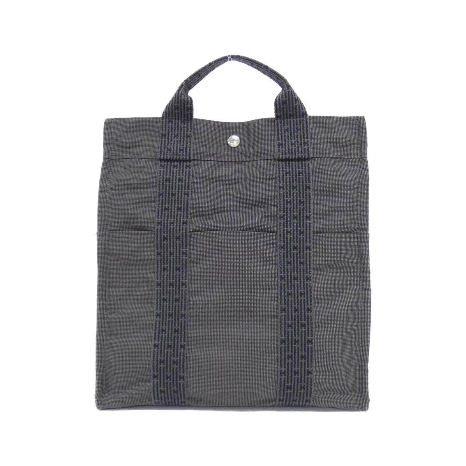 Canvas Backpack by Hermes: Canvas Backpack by Hermes Canvas Backpack by Hermes - A timeless and sleek design, this black canvas backpack features silver hardware and a compact size perfect for everyday use. Measuring just 32cm 