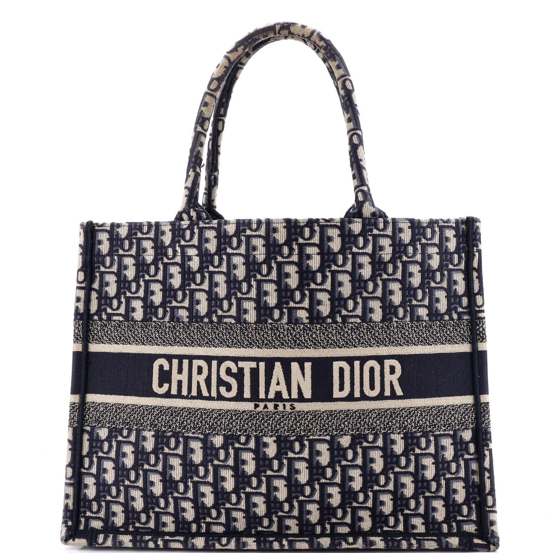 Christian Dior Book Oblique Medium Canvas Tote: Christian Dior Book Oblique Medium Canvas Tote The Christian Dior Book Oblique Medium Canvas Tote boasts a striking blue exterior with minor creases, corner wear, and discoloration. This excellent