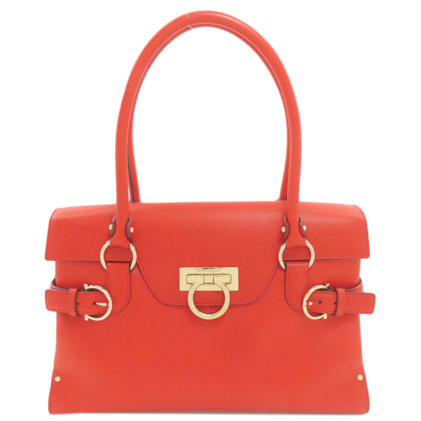 Salvatore Ferragamo Leather Tote Bag: Salvatore Ferragamo Leather Tote Bag Red leather tote bag from Salvatore Ferragamo's Gancini line, measuring 24cm x 32cm x 11cm. The bag features a classic design with a 44cm long handle, making it a 
