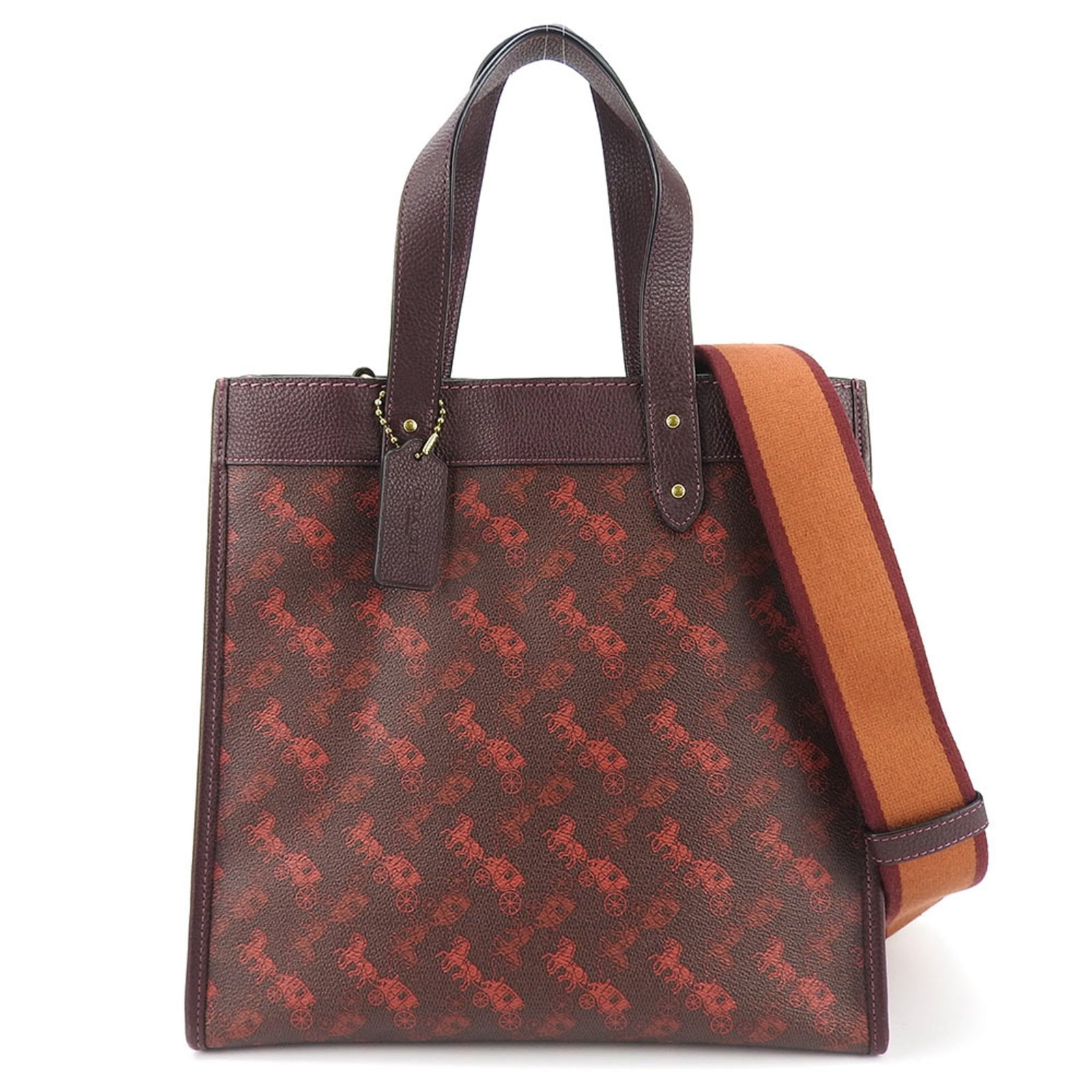 Canvas Coated Leather Bag Tote By Coach: Canvas Coated Leather Bag Tote By Coach Coated canvas and leather come together in this stylish tote bag from Coach, available in Bordeaux, Brown, and Red colors. The durable design features a sturdy 