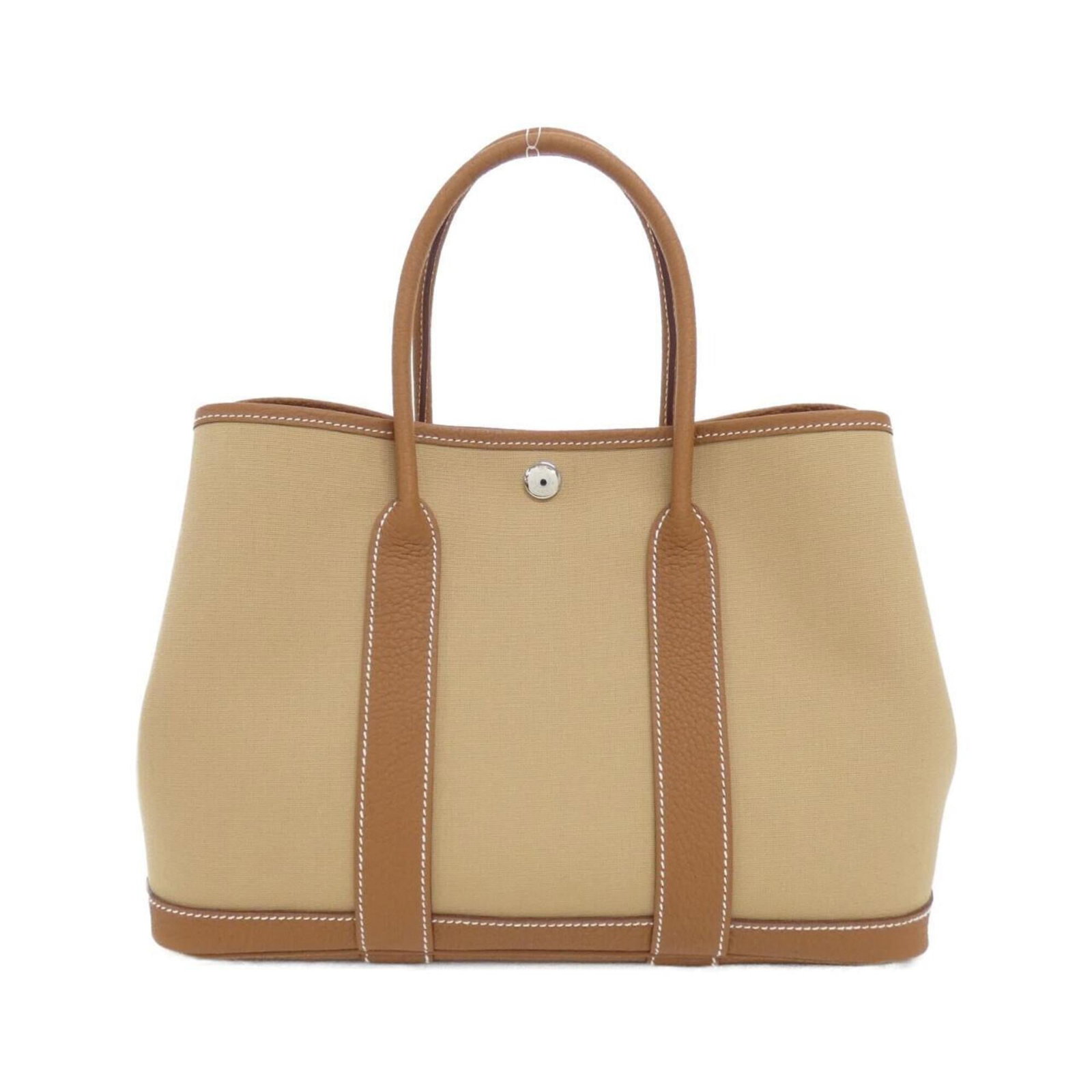 Hermes Handbag Leather Toile Officier Negonda: Hermes Handbag Leather Toile Officier Negonda Toile Officier Negonda leather, a unique and stylish material, adorns the Hermes Handbag. This beige bag features gold hardware accents in silver, adding