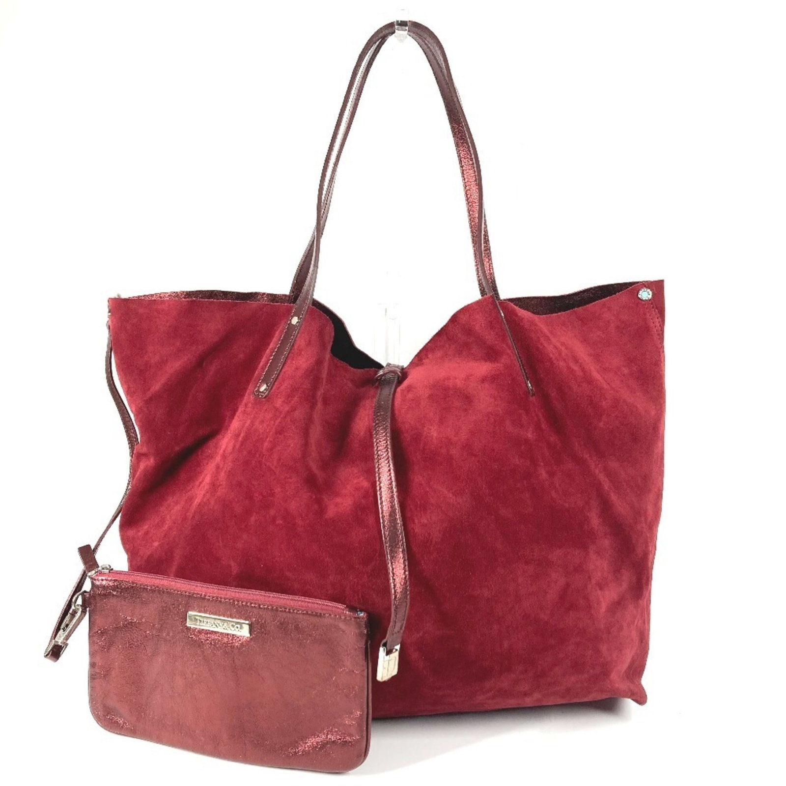 Tote bag in suede leather from Tiffany: Tote bag in suede leather from Tiffany Suede leather tote bag from Tiffany, crafted in Italy with a bold red color. Measuring 34cm x 37cm x 14cm, this shoulder bag features high-quality suede material