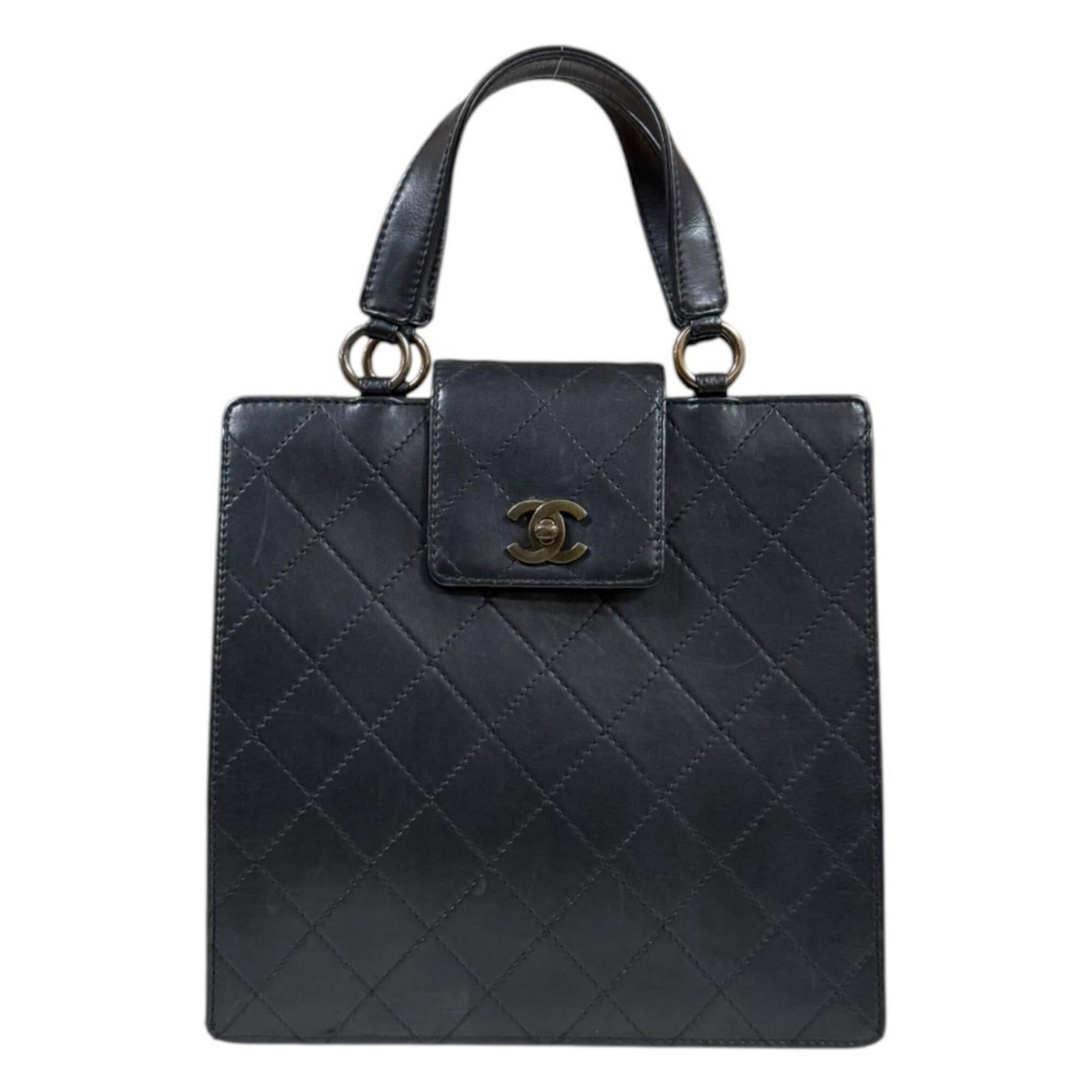 Leather Handbag Chanel: Leather Handbag Chanel This luxurious black leather handbag from Chanel features a turn lock closure, open pocket 1, and zipper pocket 1 for added convenience. Measuring 24cm x 25cm x 8.5cm, it has a 