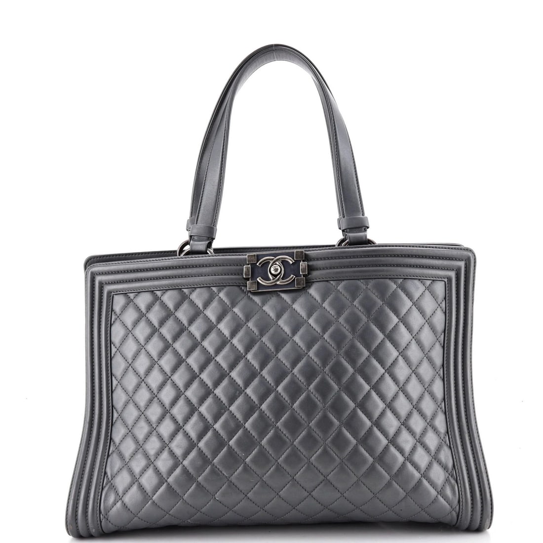 Lambskin quilted shopping tote boy Chanel large: Lambskin quilted shopping tote boy Chanel large Gray leather Boy Shopping Tote with quilted lambskin exterior, featuring top handle and aged silver hardware. Measuring 11" high, 14" wide, and 5" deep,