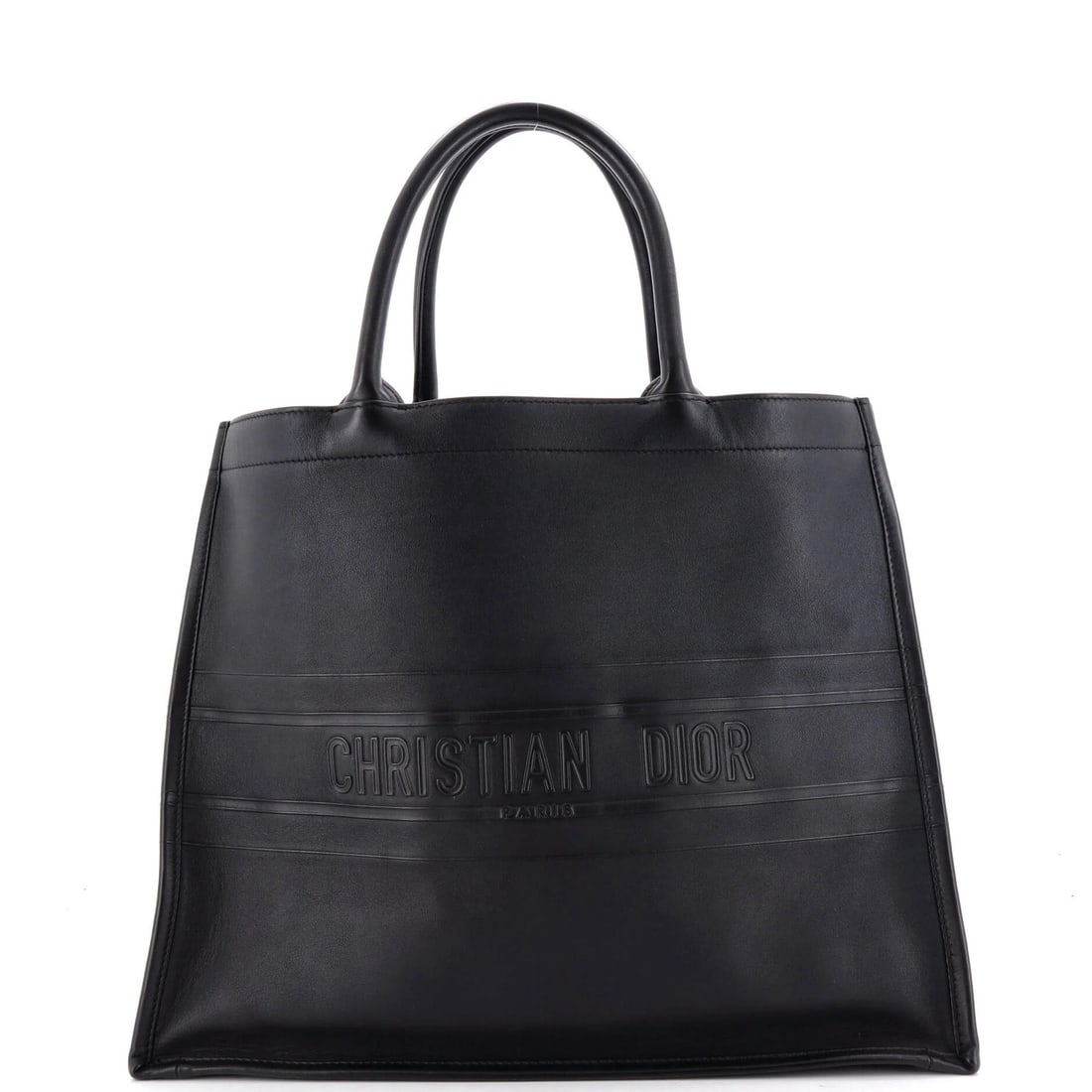 Christian Dior Book Tote Embossed Leather Large: Christian Dior Book Tote Embossed Leather Large Black Christian Dior Book Tote Embossed Leather Large tote features scuffs and creases on the exterior, with suede interior in black. Measuring 13.5"
