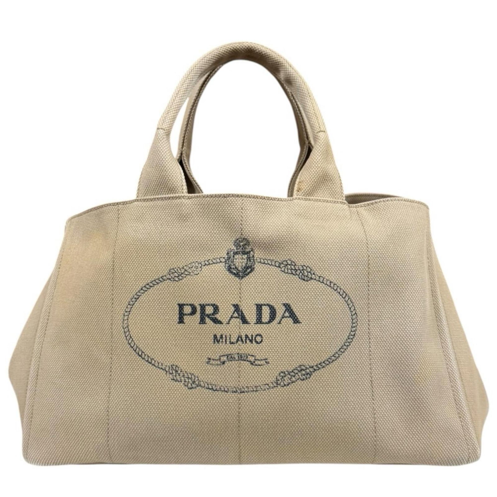 Handbag Canvas by Prada: Handbag Canvas by Prada Canvas by Prada, a beautifully crafted handbag made from high-quality canvas, boasts a classic beige color and an open closure. Measuring 24cm x 40cm x 25cm, this stylish bag