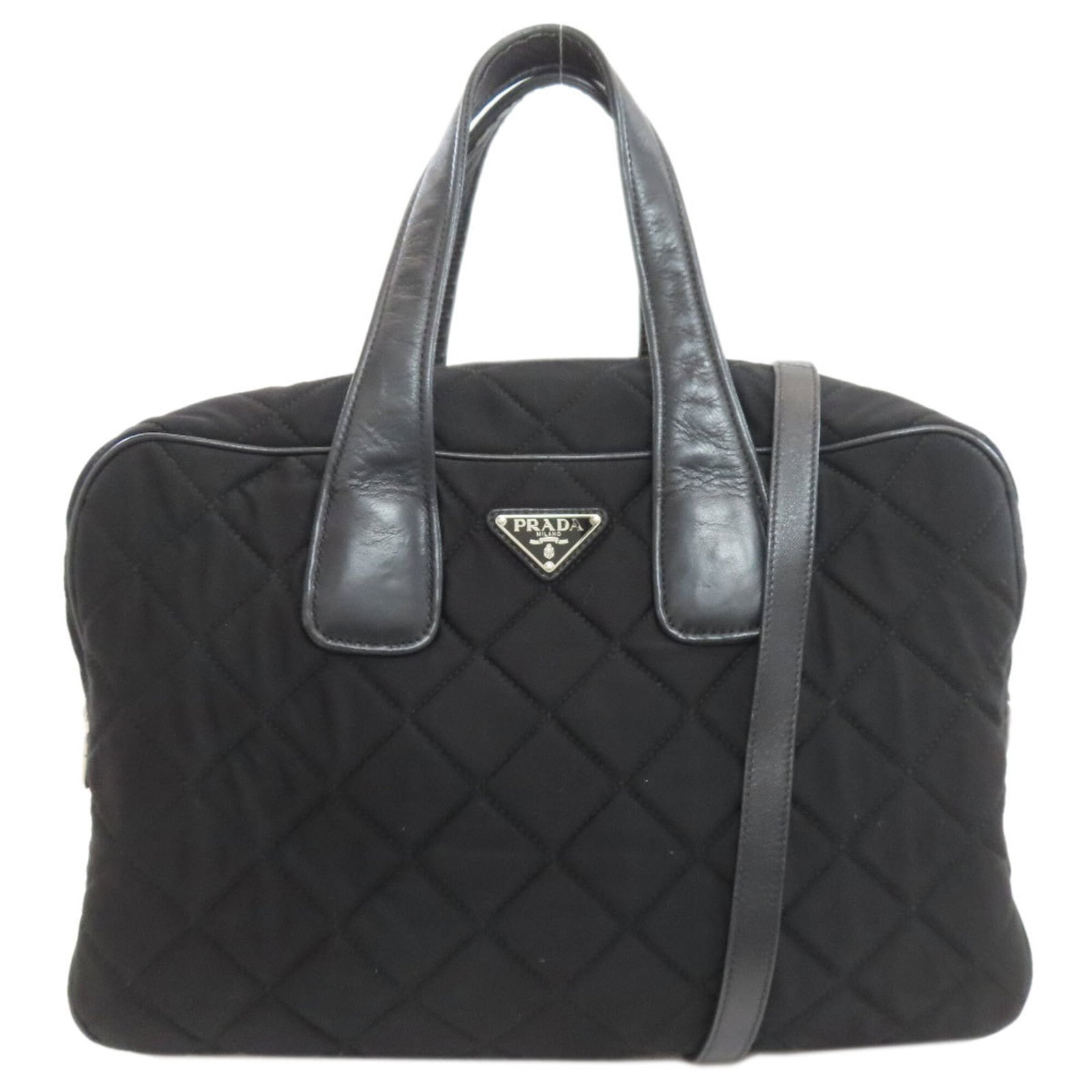 Prada Handbag Cotton Canvas: Prada Handbag Cotton Canvas Black cotton canvas Prada handbag with zipper closure, available in dimensions 26cm x 38cm x 15cm. The bag features adjustable strap lengths and a handle length of 40cm, ma