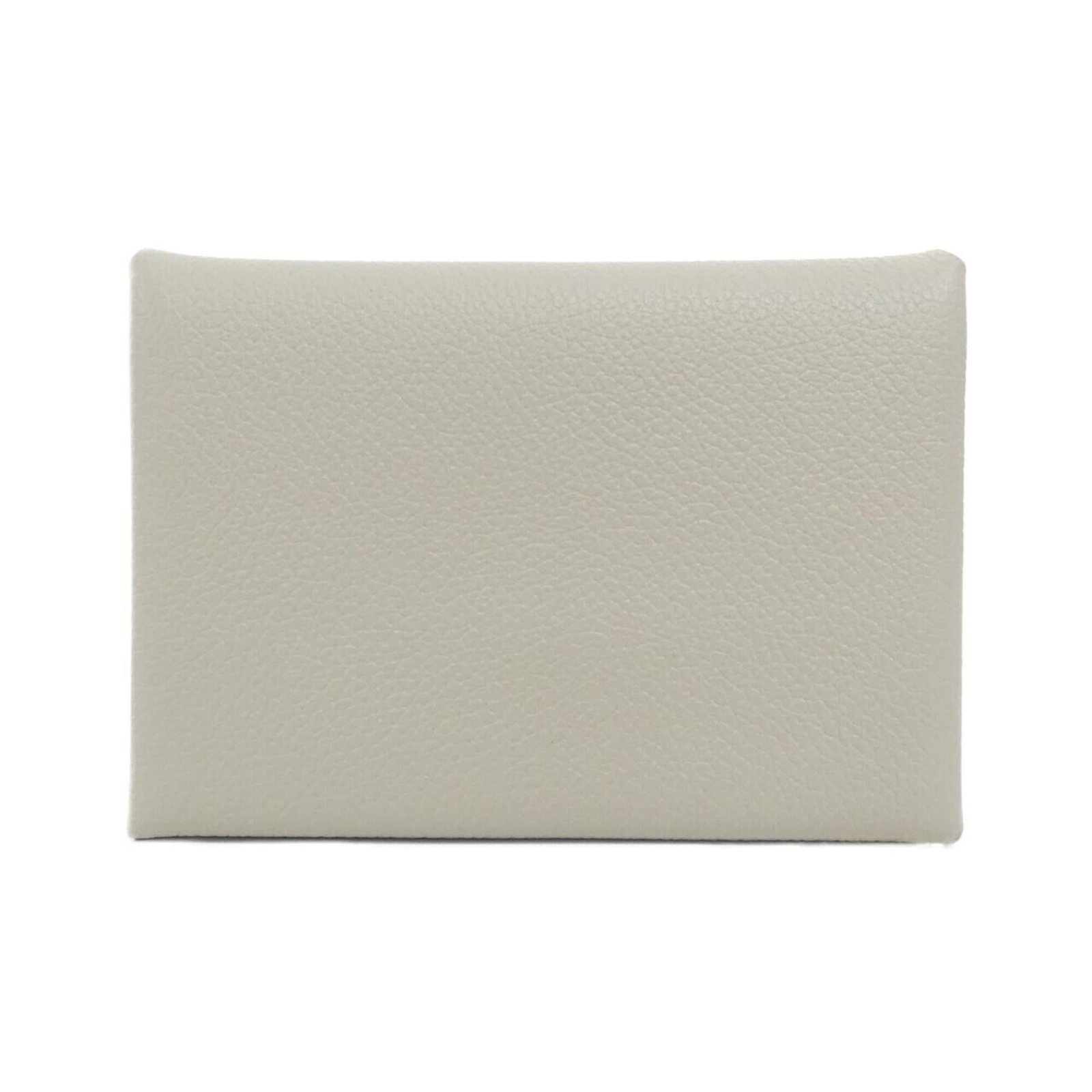 Hermes Coin Purse/ Coin Case Evercalf Leather: Hermes Coin Purse/ Coin Case Evercalf Leather Evercalf leather craftsmanship meets timeless design in this sleek Hermes coin purse/coin case. Made from high-quality Evercalf leather, its crisp white f