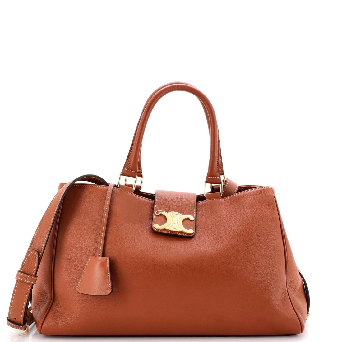 Calfskin Handbag By Celine Appoline: Calfskin Handbag By Celine Appoline Calfskin Handbag by Celine Appoline features a classic medium size with a brown exterior and suede interior. The bag boasts gold hardware and comes with a clochette