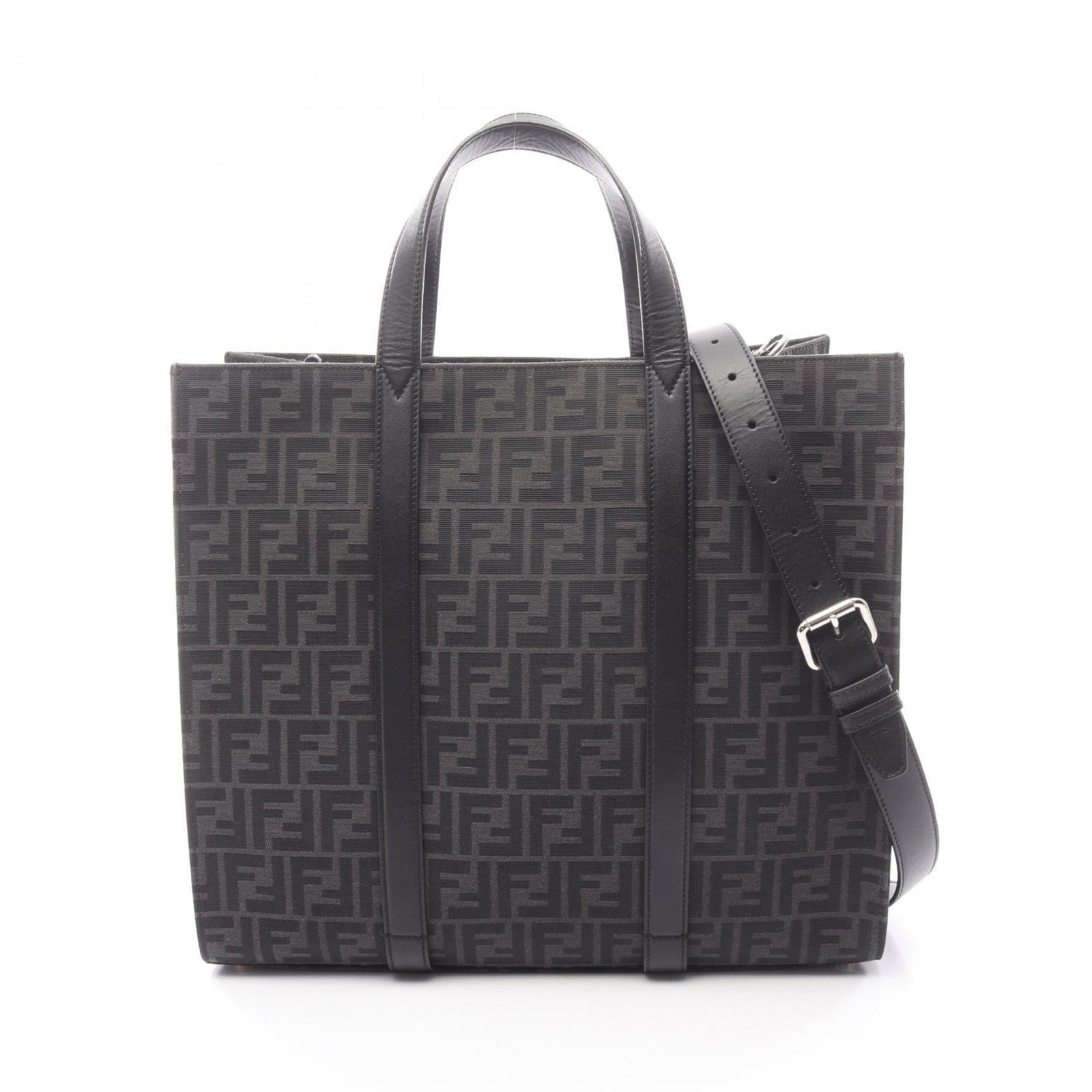 Canvas Leather Tote Bag By Fendi: Canvas Leather Tote Bag By Fendi Canvas Leather Tote Bag by Fendi. This stylish tote bag features a striking combination of canvas and leather materials, presented in sleek black and gray hues. With