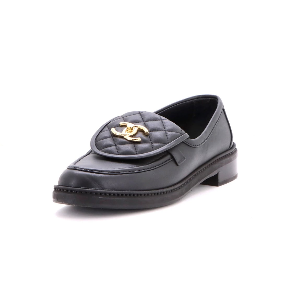 Women's CC quilted leather loafers by Chanel: Women's CC quilted leather loafers by Chanel Black quilted leather loafers with gold hardware, featuring a classic design and premium materials. The shoes showcase subtle signs of wear, including crea