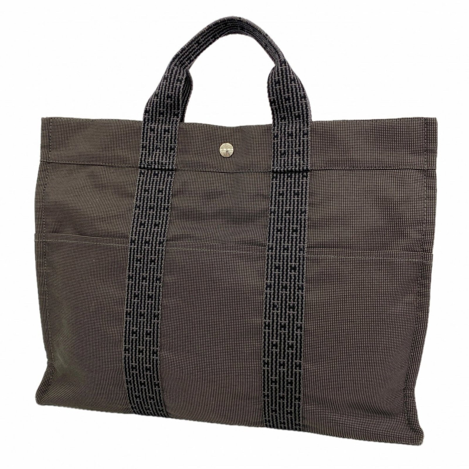 Canvas Hermes Tote Bag: Canvas Hermes Tote Bag Canvas tote bag from Hermes, featuring gray canvas material and silver hardware. This stylish tote measures 33cm x 42.5cm x 11cm and has a sleek, modern design. The bag's canvas