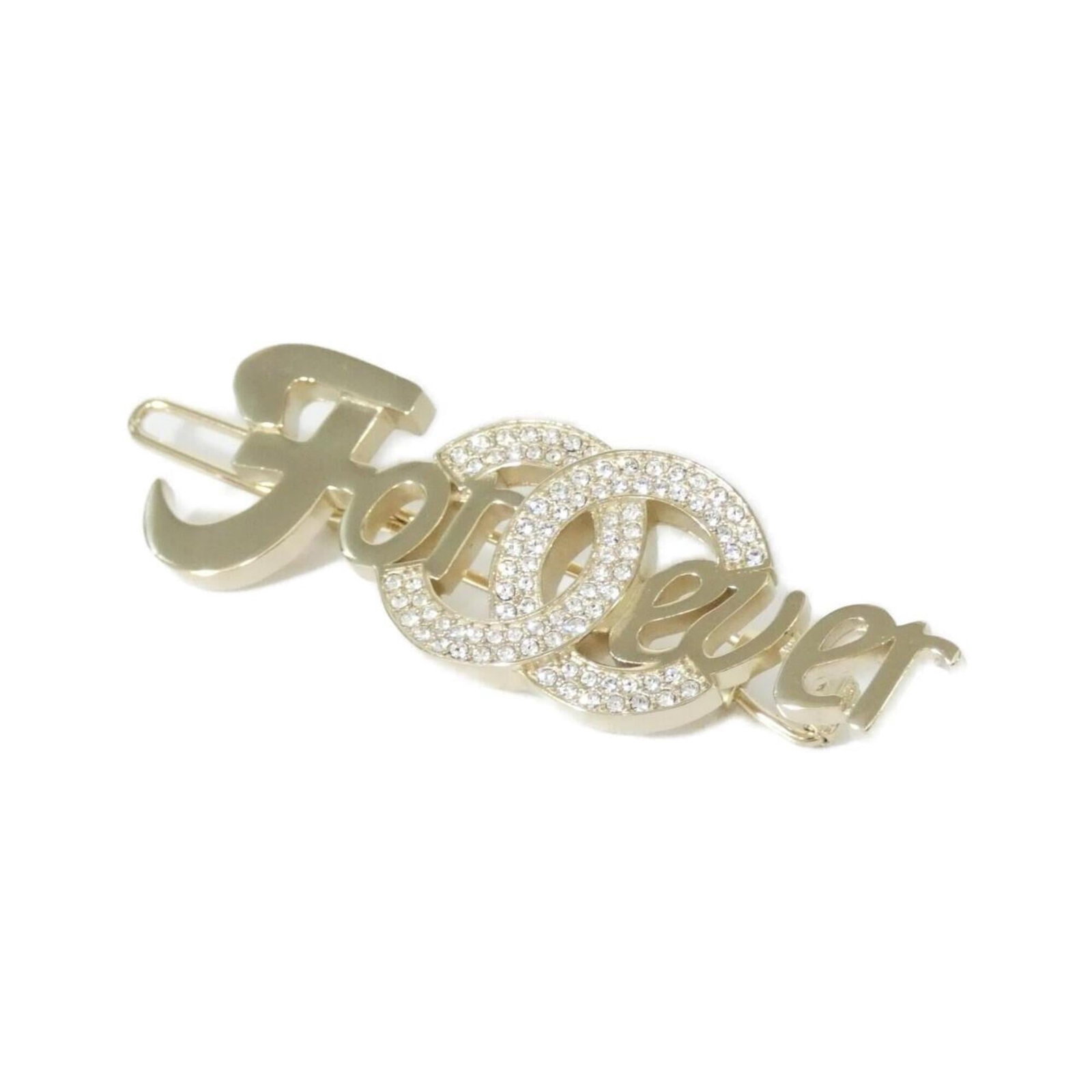 Barrette of Chanel: Barrette of Chanel Gold barrette with crystal stone, measuring 1.7cm x 5.5cm in size, bearing the iconic Chanel brand. This elegant accessory features a striking gold finish and a prominent crystal ac