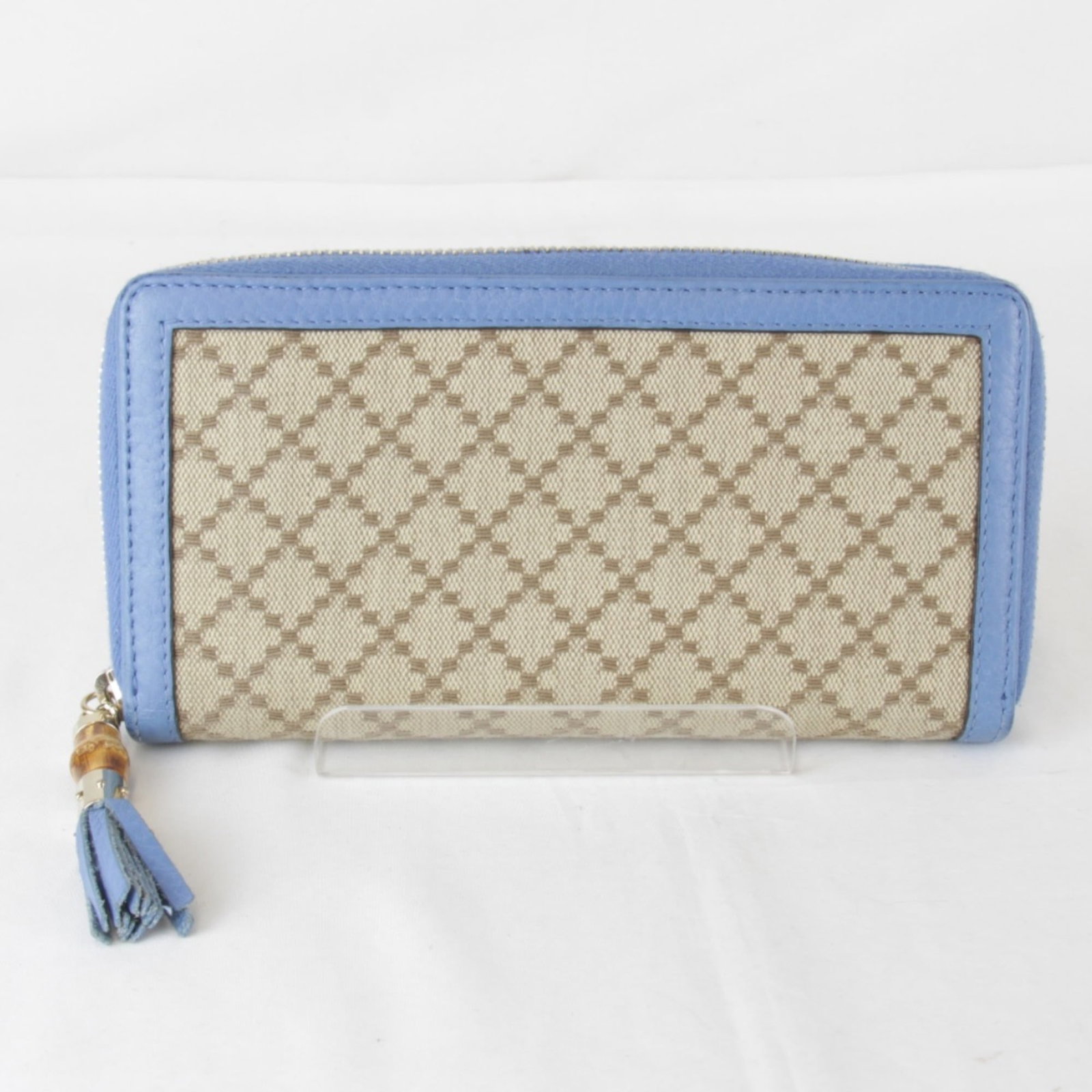 Gucci Long Wallet (Bi-Fold) Canvas Leather: Gucci Long Wallet (Bi-Fold) Canvas Leather Canvas and leather blend in this Gucci long wallet, featuring a zipper closure, three bill slots, a coin purse, and twelve card slots. The bi-fold design pro