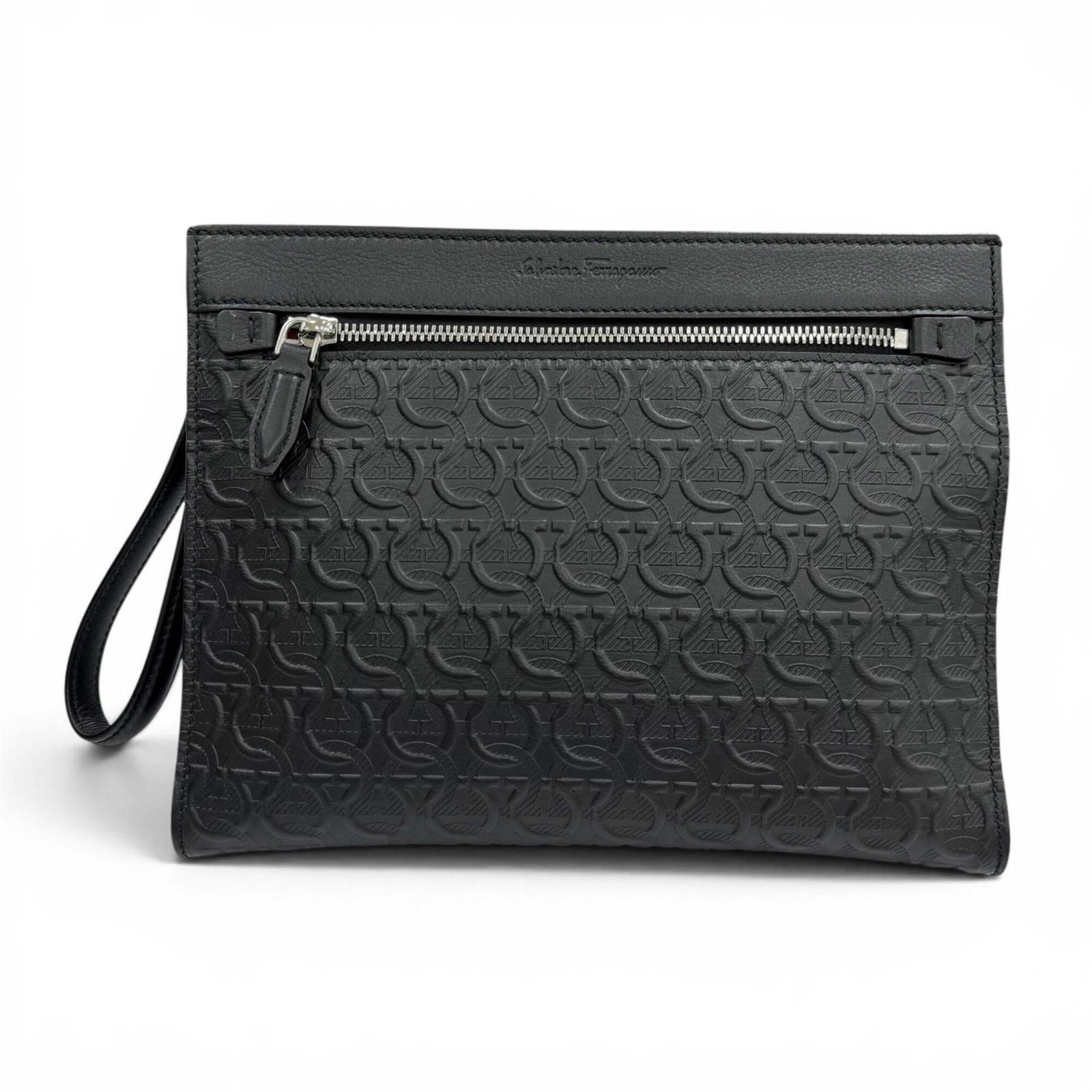 Ferragamo Salvatore Leather Clutch Bag: Ferragamo Salvatore Leather Clutch Bag The Salvatore Ferragamo Leather Clutch Bag is a sleek and sophisticated accessory, crafted from high-quality black leather. Measuring 20.5cm x 26.8cm x 3cm in