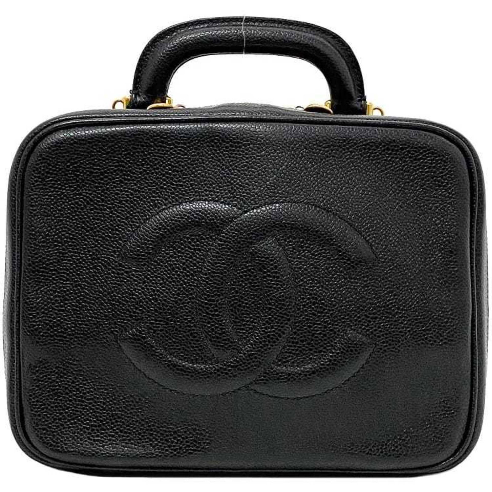 Vanity bag leather handbag Chanel: Vanity bag leather handbag Chanel Black leather Chanel A07061 vanity bag with zipper pocket and rubber band closure. This stylish handbag measures 18cm x 24cm x 10cm and comes with a guarantee card.