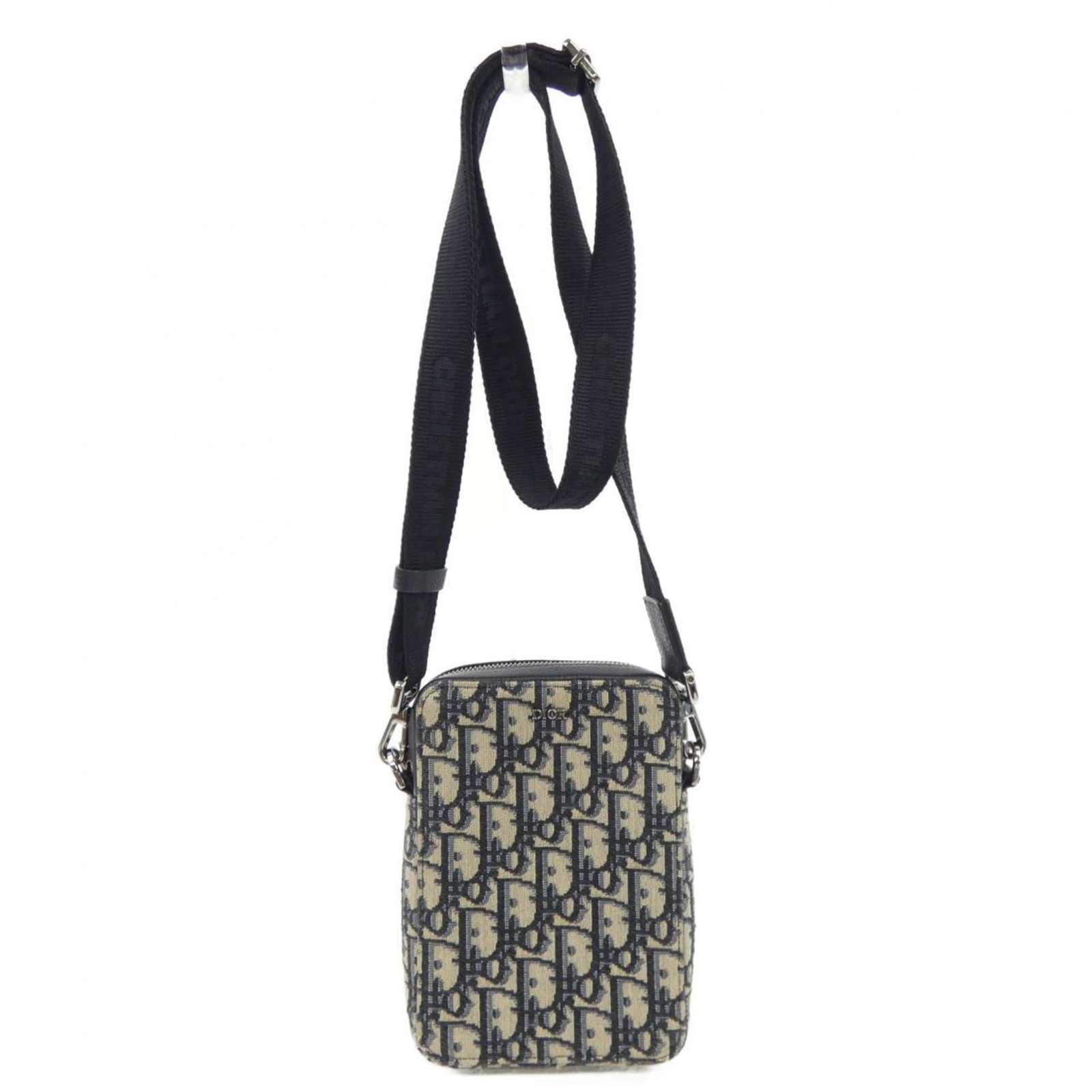 Handbag by Christian Dior: Handbag by Christian Dior Handbag by Christian Dior in beige and navy, featuring a shoulder strap accessory. This classic design boasts a compact size with dimensions of 17.5cm x 12cm x 4cm, making