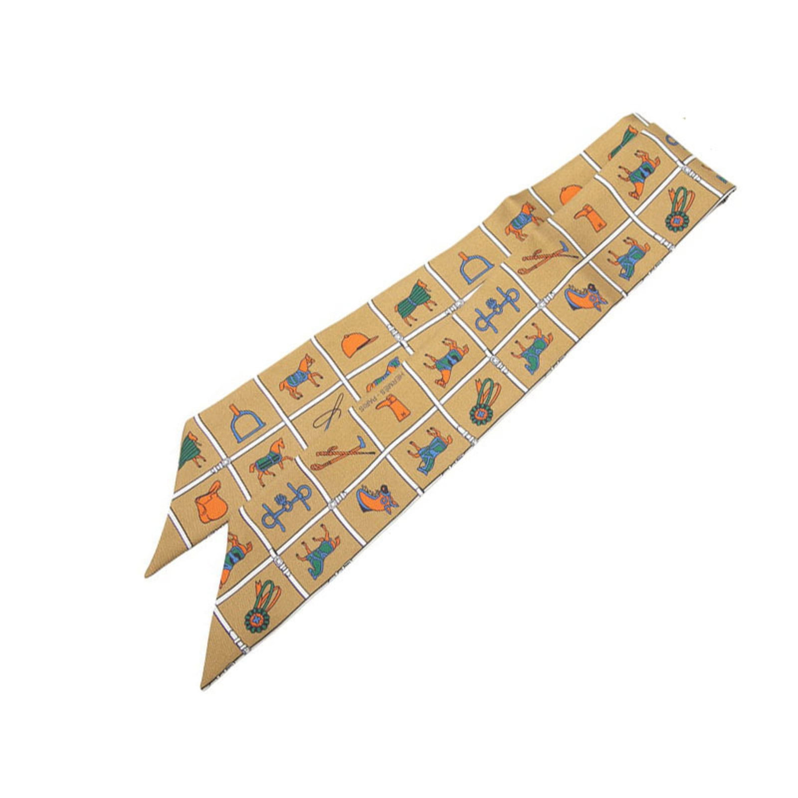 Hermes Silk Scarf: Hermes Silk Scarf Silk scarf from renowned brand Hermes, featuring a rich brown color and elegant dimensions of 85cm x 5cm. Made from high-quality silk, this accessory boasts a slim profile that adds 