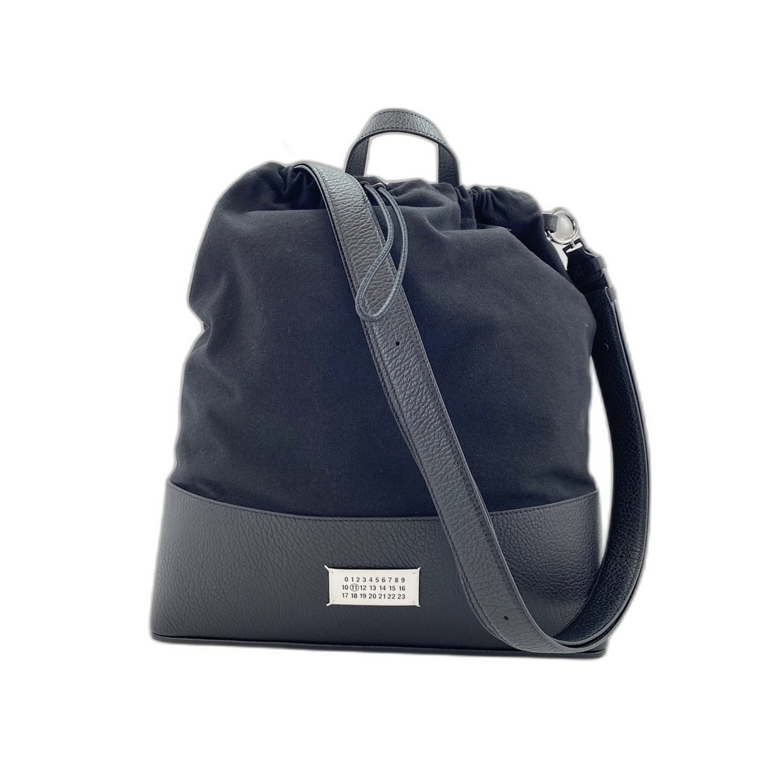 Canvas Maison Margiela Backpack: Canvas Maison Margiela Backpack Canvas Maison Margiela Backpack in Black features a canvas material, black color, and measures 37cm x 38cm x 9cm. The backpack has adjustable strap length of 92cm and h