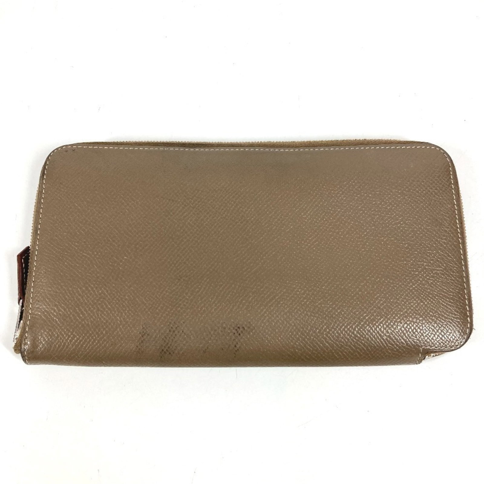 Epsom Leather Bi Fold Wallet Hermes: Epsom Leather Bi Fold Wallet Hermes Epsom leather bi-fold wallet from the iconic Hermes line, crafted in France with a distinctive gray color and sleek design. This elegant accessory features a