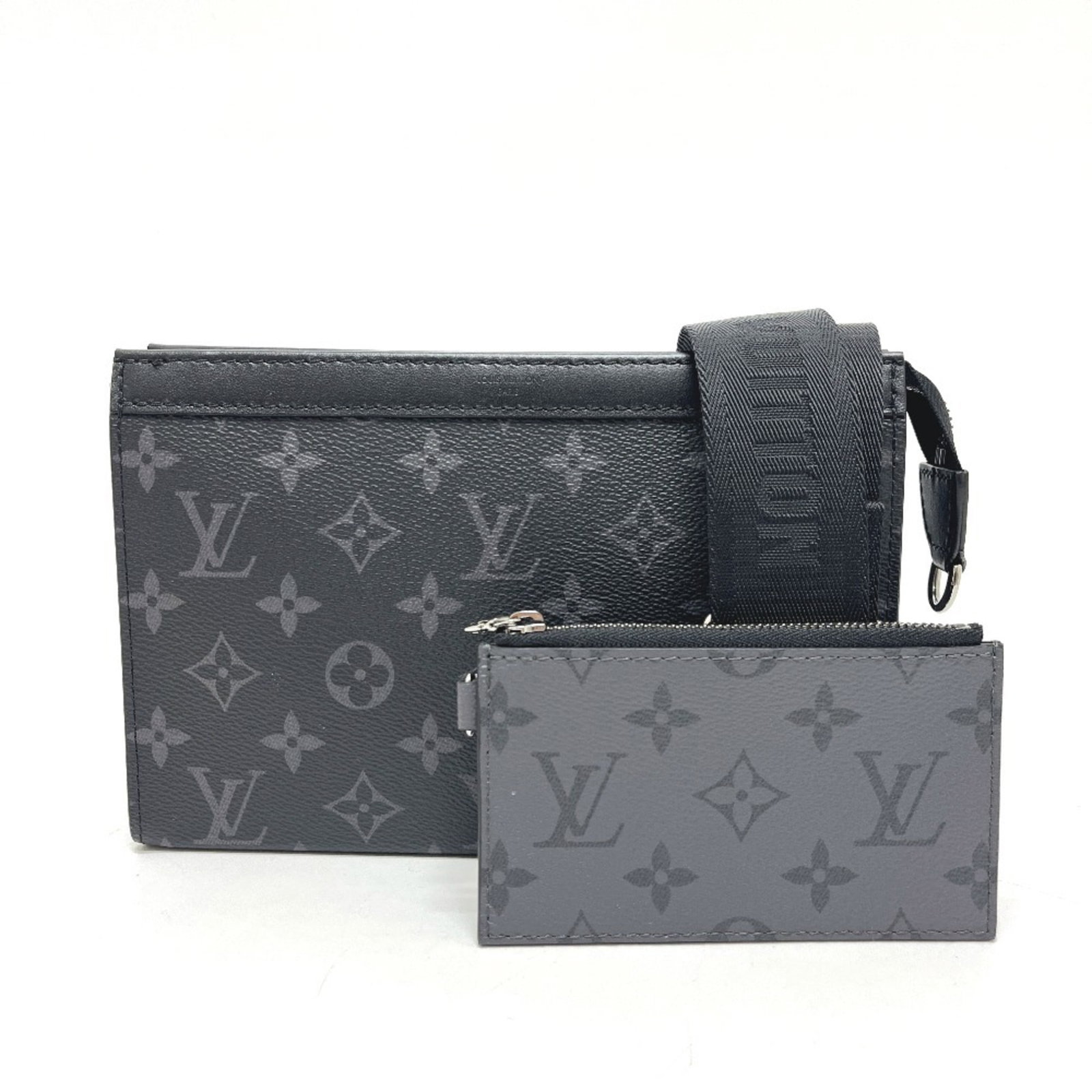 Louis Vuitton Handbag Pouch Shoulder Bag Monogram Eclipse: Louis Vuitton Handbag Pouch Shoulder Bag Monogram Eclipse Monogram Eclipse details add an edgy touch to this sleek Louis Vuitton shoulder bag pouch. Measuring 14.5cm x 22cm x 4.5cm, it features a stri