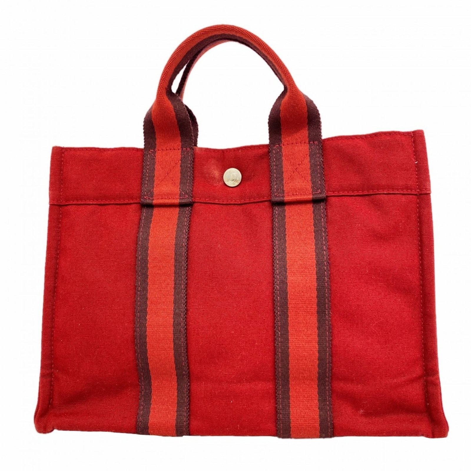 Handbag Canvas by Hermes: Handbag Canvas by Hermes Red canvas handbag with silver hardware, measuring 23.5cm x 31cm x 8cm. This Herm?s bag features a striking red color and sleek design, showcasing the brand's signature style.