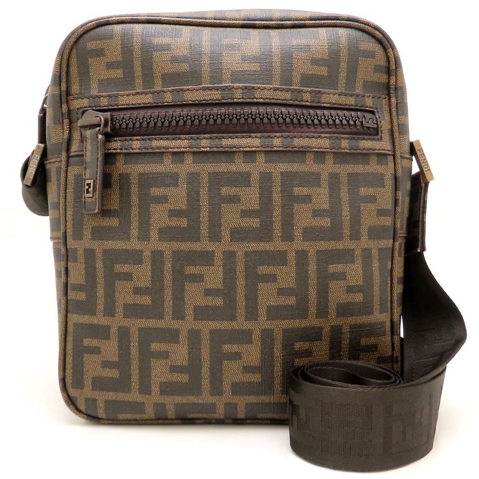 Shoulder Bag Canvas Coated By: Shoulder Bag Canvas Coated By Coated canvas shoulder bag from Fendi's Zucchino line, featuring a sturdy and stylish design with a brown finish. The bag boasts a functional zipper closure and adjustabl