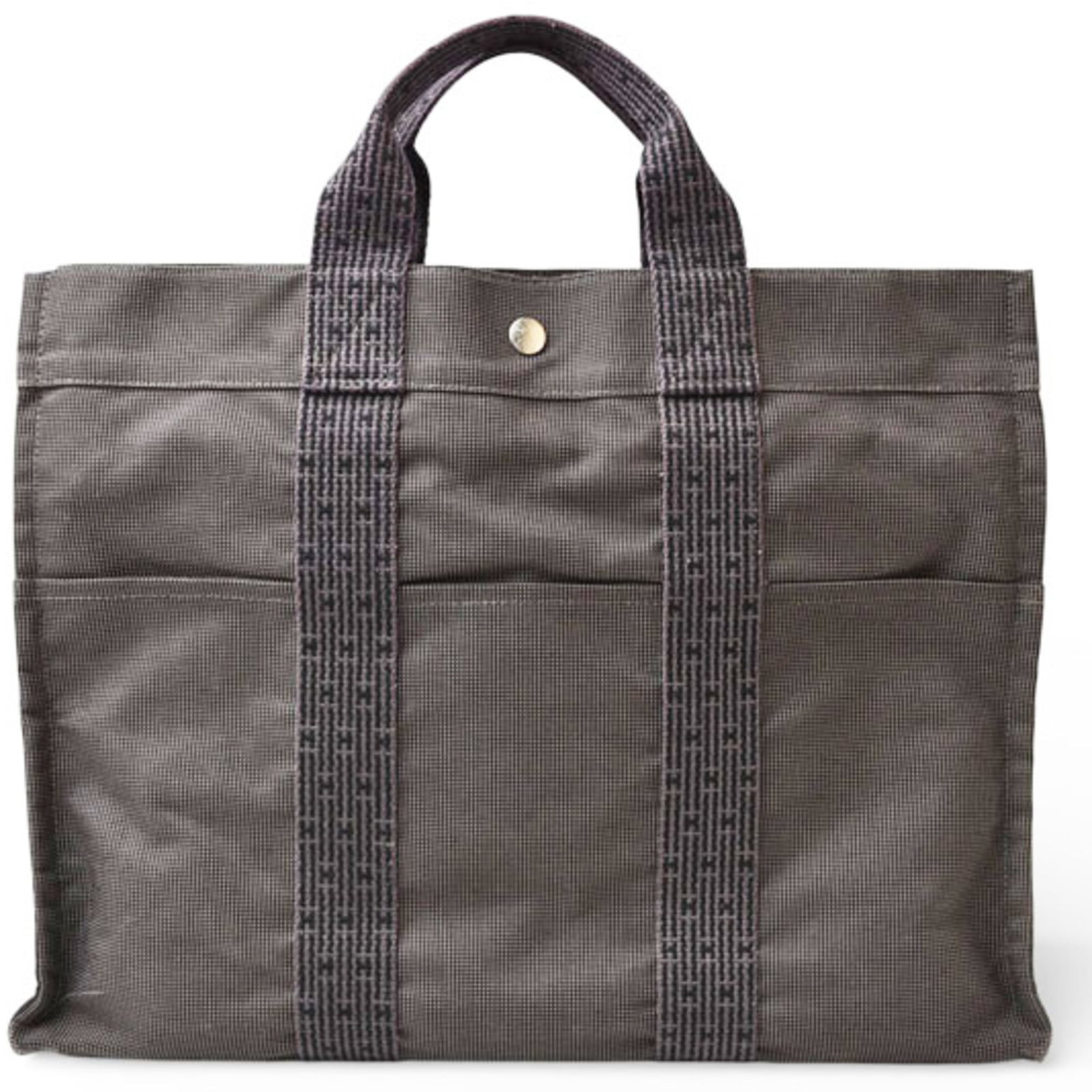 Handbag Tote Bag of Canvas by Hermes: Handbag Tote Bag of Canvas by Hermes Canvas tote bag from the iconic Herm?s line, crafted in France with a versatile gray color and sleek silver hardware. This timeless piece features a sturdy canvas