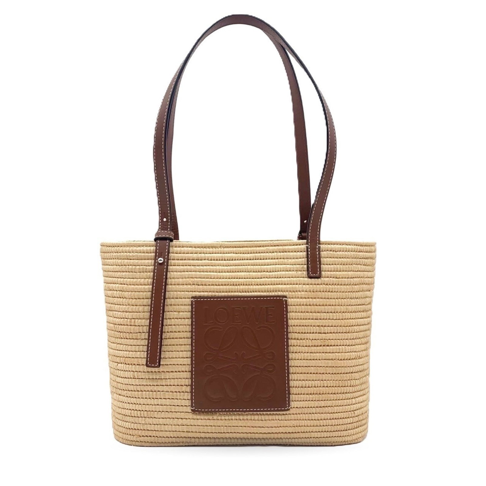 Raffia Leather Loewe Tote Basket: Raffia Leather Loewe Tote Basket Raffia and leather combine in this elegant Loewe tote basket, measuring 20.5cm x 27cm x 10cm. The beige color and natural texture of the raffia add warmth to this styl