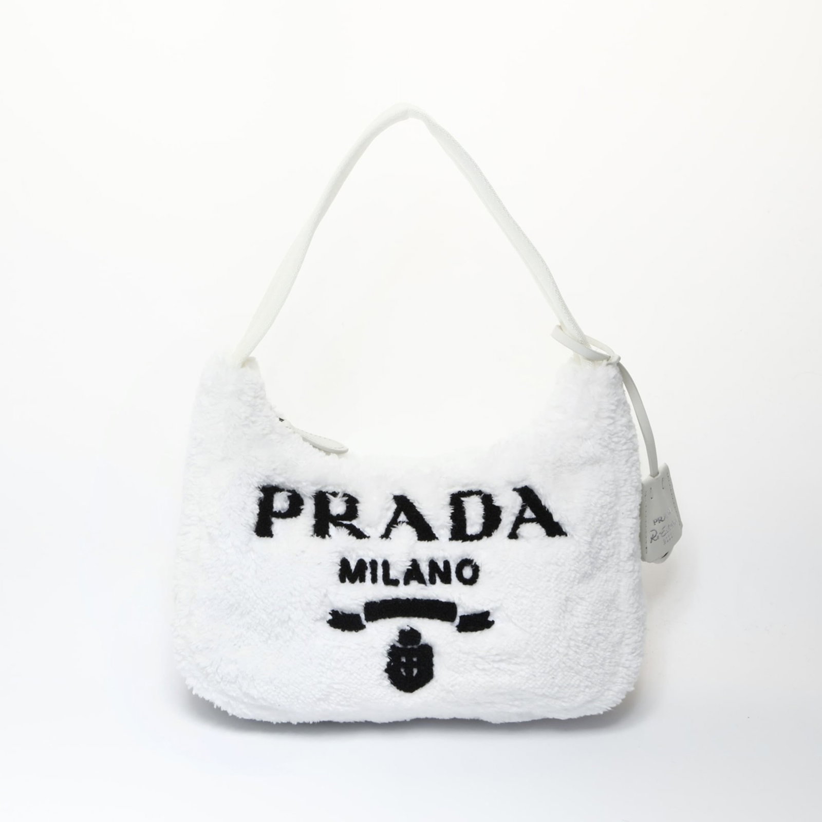Shoulder Bag: Shoulder Bag White Prada shoulder bag with a sleek design, measuring 17cm x 25cm x 7cm and featuring a 32cm strap length. This stylish accessory boasts clean lines and a compact size, making it perfec