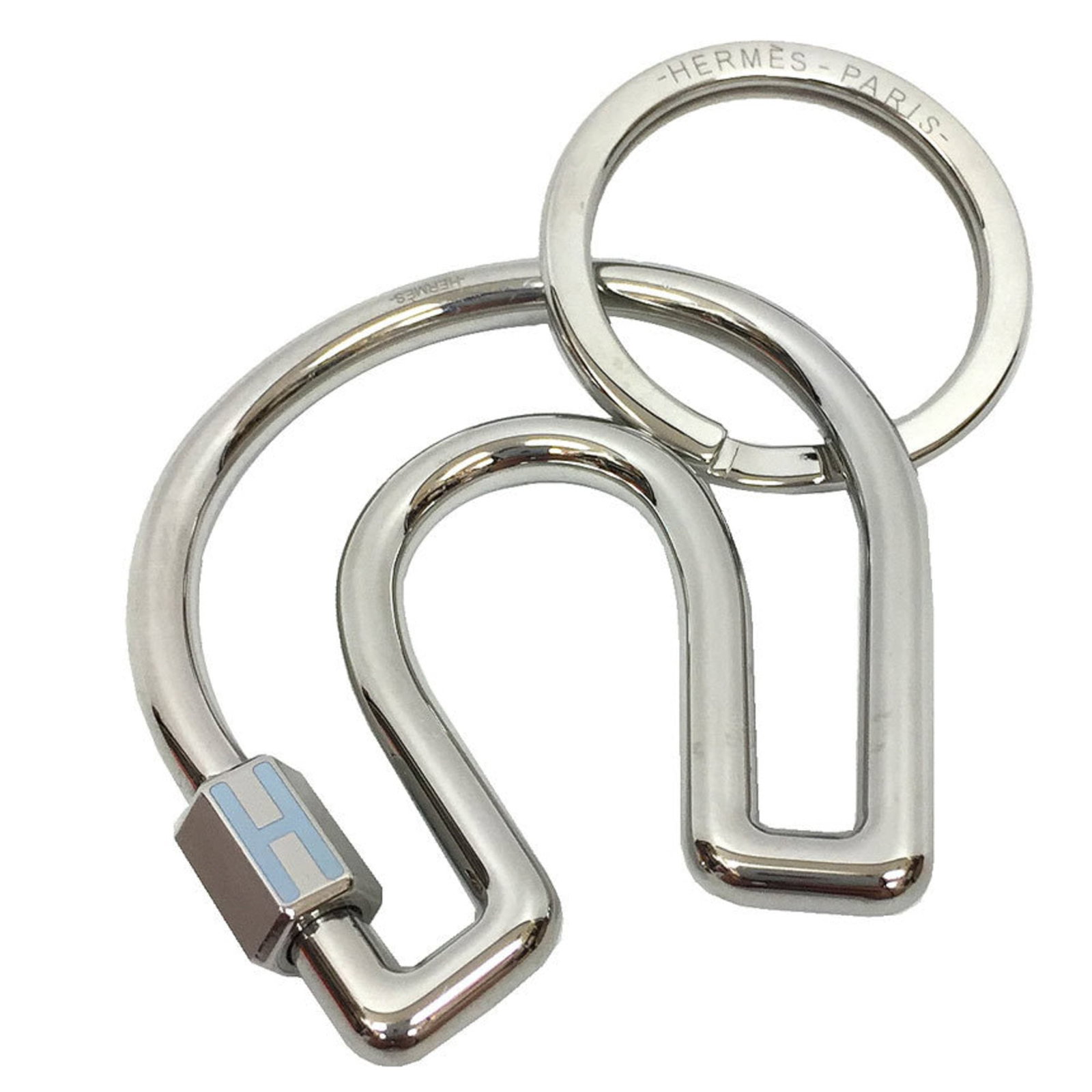 Keyring Metal By Hermes: Keyring Metal By Hermes Silver metal keyring by iconic luxury brand Hermes, beautifully packaged in a box and dust bag. The sleek design showcases the signature style of this renowned fashion house,