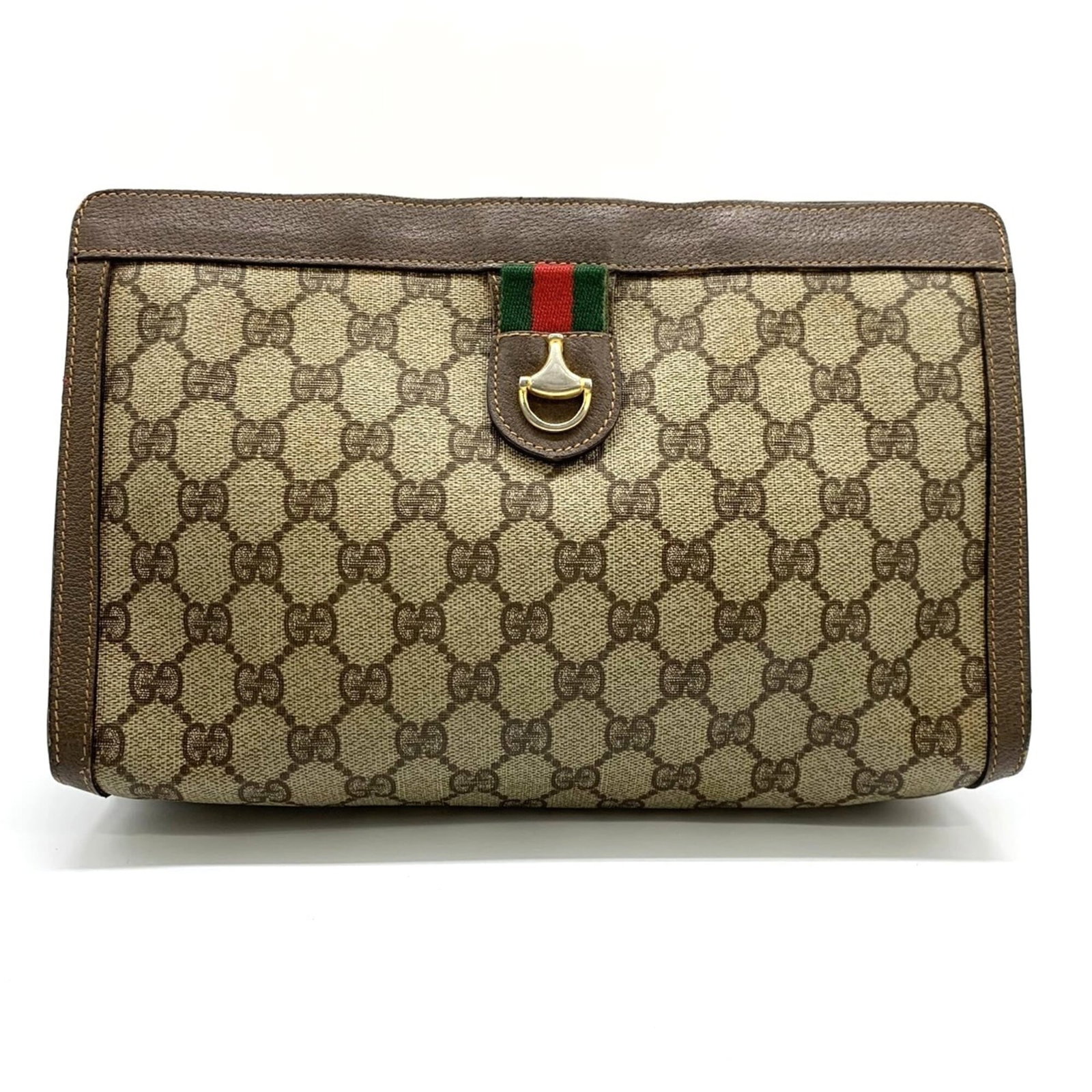 Clutch bag by Gucci: Clutch bag by Gucci Brown Gucci clutch bag with velcro closure, measuring 18cm x 27cm x 7cm. This stylish accessory features a classic design and a versatile size perfect for evening events. The signa