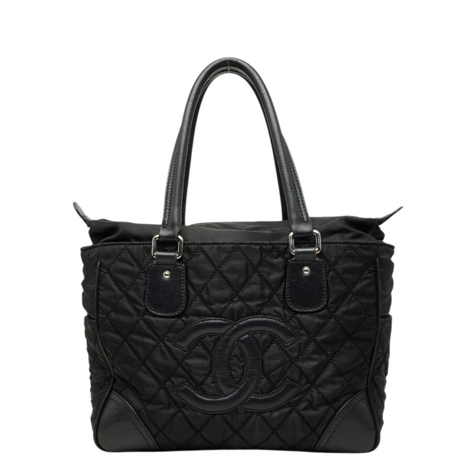 Nylon Leather Shoulder Bag Tote Bag by Chanel: Nylon Leather Shoulder Bag Tote Bag by Chanel Nylon and leather combine in this sleek Chanel shoulder bag, featuring calfskin accents. Measuring 24cm x 32cm x 15.5cm, it offers a spacious interior for