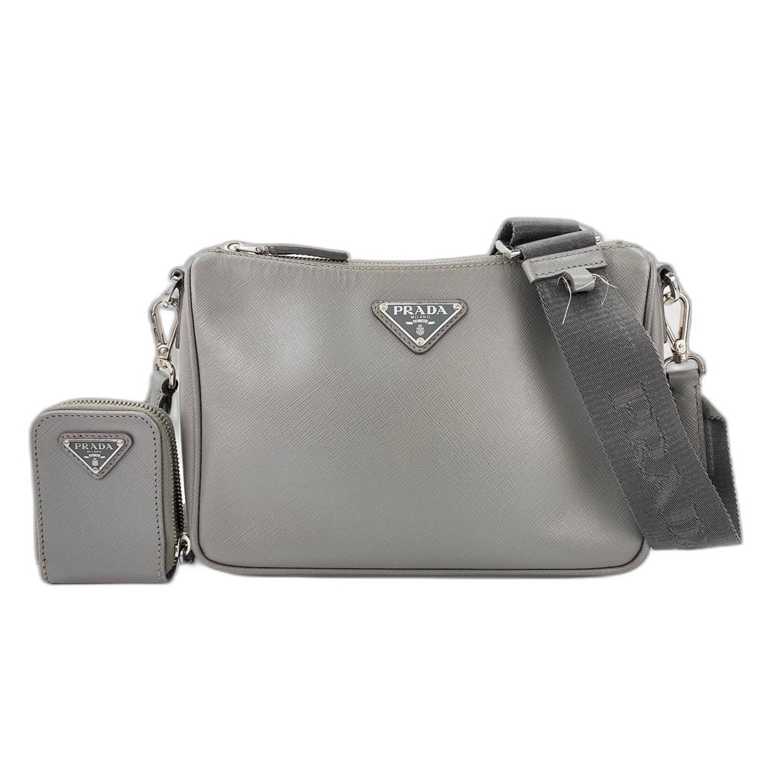 Shoulder Bag: Shoulder Bag Gray Prada shoulder bag with a sleek design, measuring 17cm x 25cm x 5cm. The bag features a sturdy strap length of 97cm and bears no serial number on its body. Its neutral color makes it
