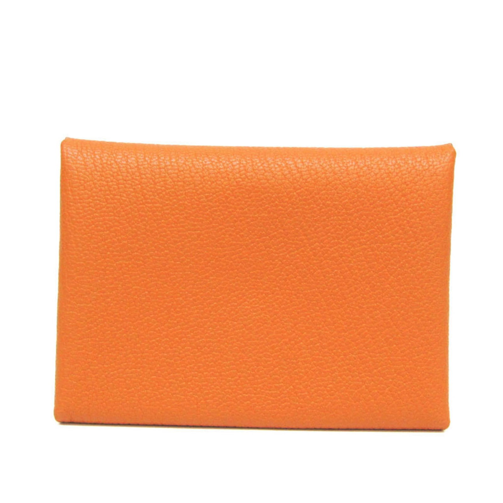 Chevre leather card case by Hermes: Chevre leather card case by Hermes Chevre leather card case by Hermes boasts a vibrant orange hue and sleek design, featuring a snap fastener closure and button pocket for added functionality. Made fr