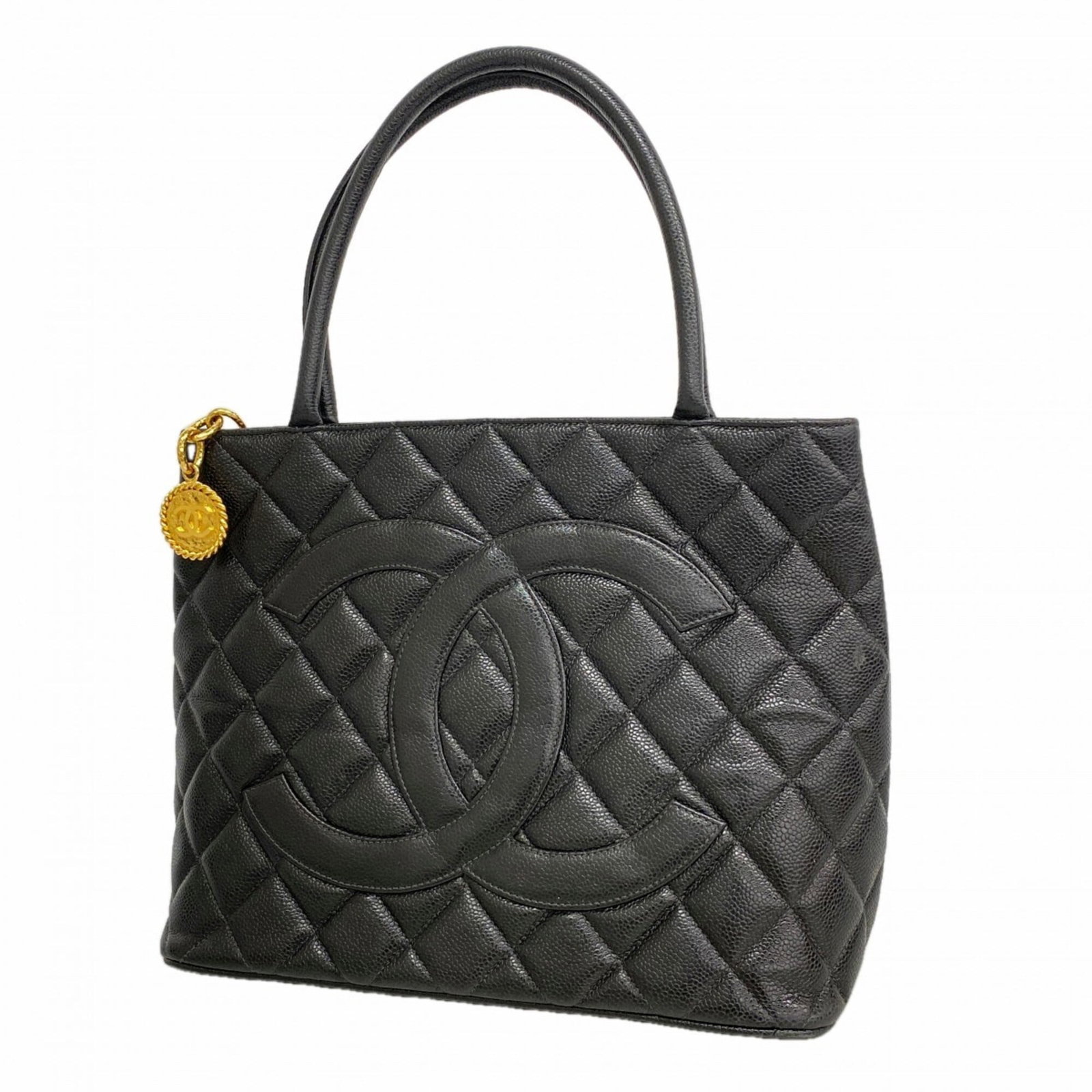 Calfskin bag tote by Chanel: Calfskin bag tote by Chanel Calfskin bag tote by Chanel, featuring grained Calfskin material and gold hardware. This black tote measures 24.5cm x 30cm x 15cm and boasts a classic design that exudes